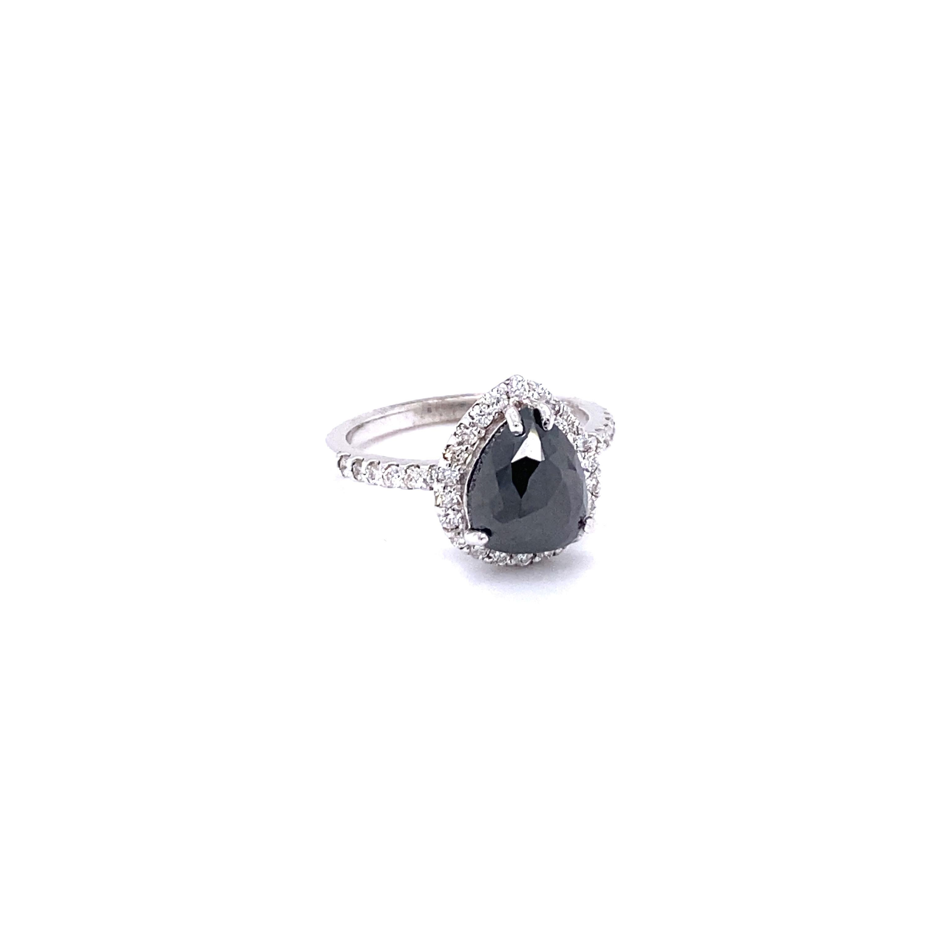 Pear Cut Black and White Diamond Engagement Ring
Description as follows:

Pear Cut Dia weighs 2.43 carats and measures at 10 mm x 8 mm
34 Round Cut Diamonds weigh 0.49 carats (Clarity: SI, Color: F)
14 Karat White Gold approximately 3.4 grams
 Ring