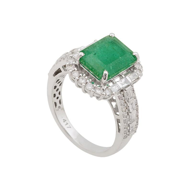 This ring has been meticulously crafted from 10-karat gold.  It is hand set with 2.92 carats emerald & 1.05 carats of sparkling diamonds. 

The ring is a size 7 and may be resized to larger or smaller upon request. 
FOLLOW  MEGHNA JEWELS storefront