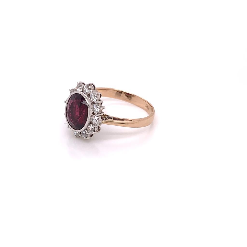 A Lustrous and Radiant Oval Brilliant blood red Ruby weighing approximately 2.92 carats is at the centre of this extraordinary 18k rose gold ring. Surrounded by a cluster of Round Brilliant Diamonds weighing approximately 0.51 carats, this Stunning