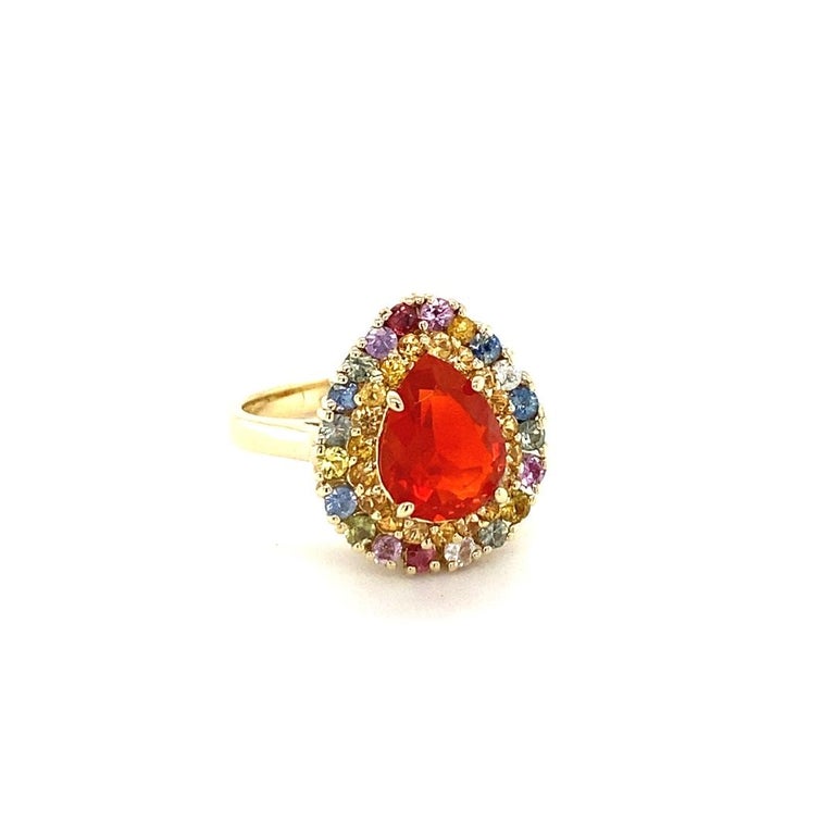 2.92 Carat Pear Cut Natural Fire Opal Sapphire Yellow Gold Cocktail Ring

Item Specs:

Natural Fire Opal (Pear Cut) = 1.63 Carats
19 Natural Yellow Sapphires (Round Cut) = 0.46 Carats
20 Natural Multi-Color Sapphires (Round Cut) = 0.83 Carats
Total