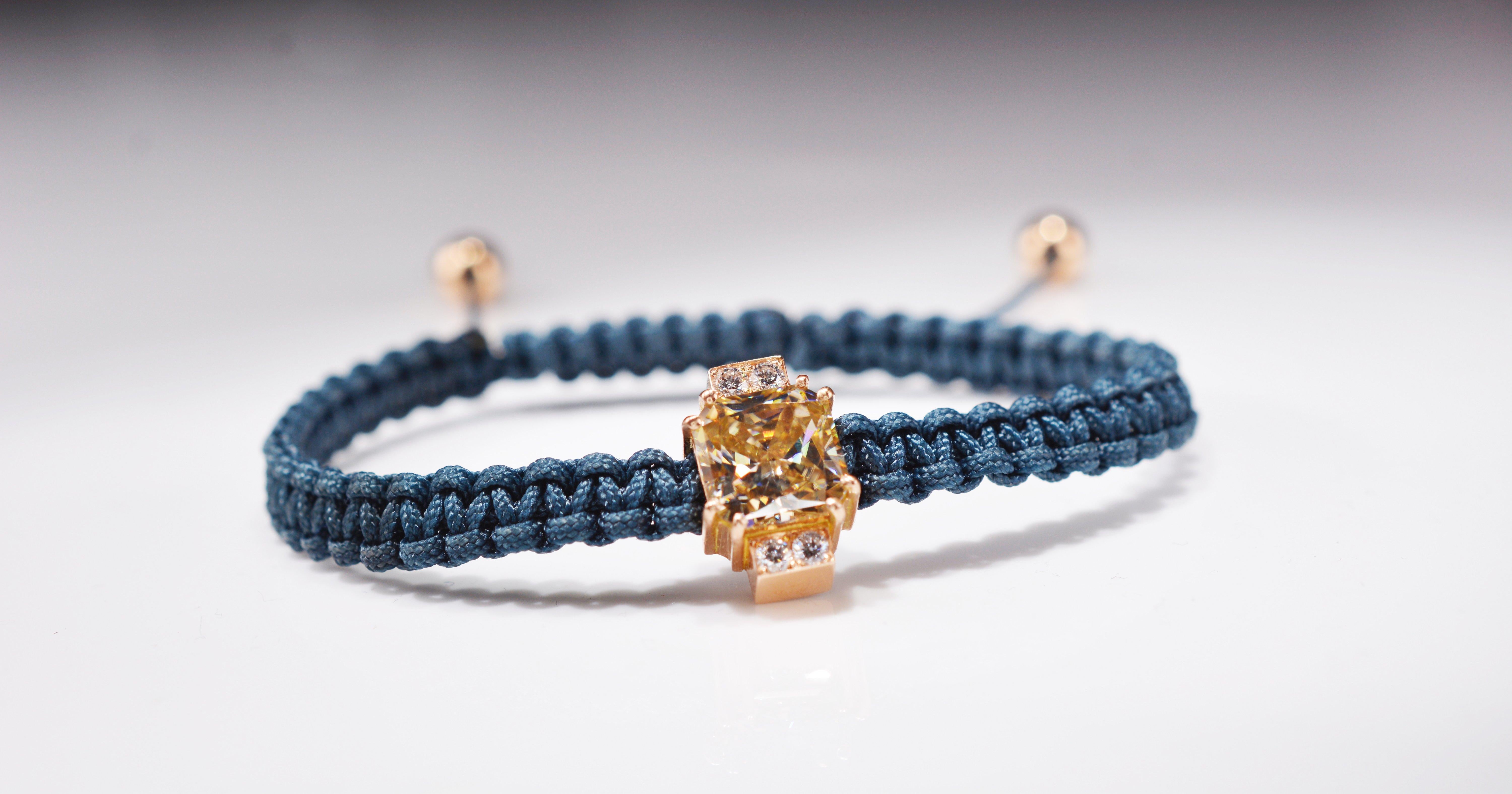 Contemporary unisex macramé bracelet, featuring a 2.92 carat Radiant cut fancy light yellow Moissanite center stone set in 18 karat rosé gold accompanied by 0.24 carat (4 x 0.06ct) F/VS round diamonds.
The ends on the bracelet are also made out of