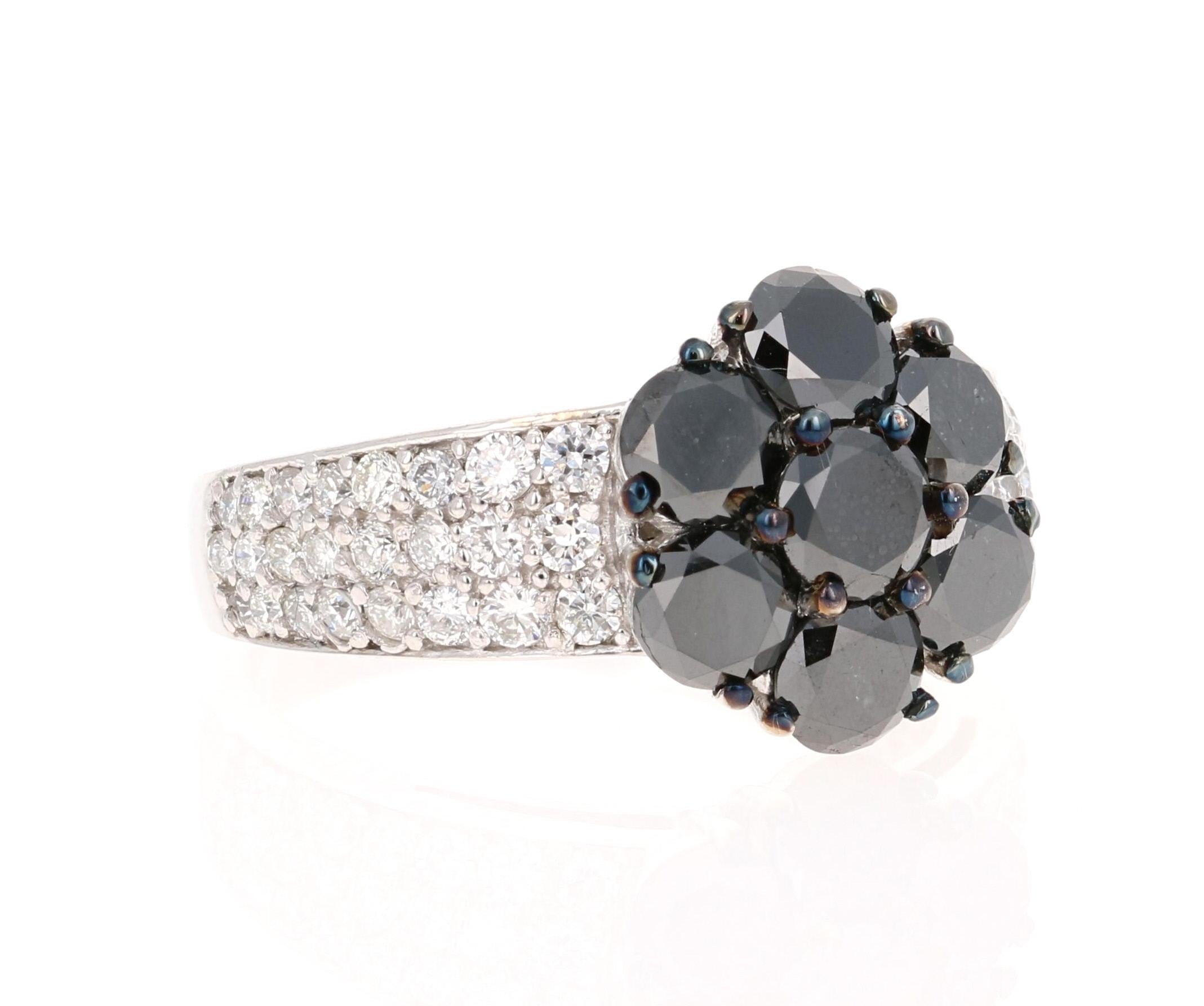 There are 7 Black Round Cut Diamonds that weigh 2.17 Carats and they are surrounded by 48 Round Cut Diamonds that weigh 0.75 Carats. 
The total carat weight of this ring is 2.92 Carats. 
This ring is made in 14K White Gold and weighs approximately