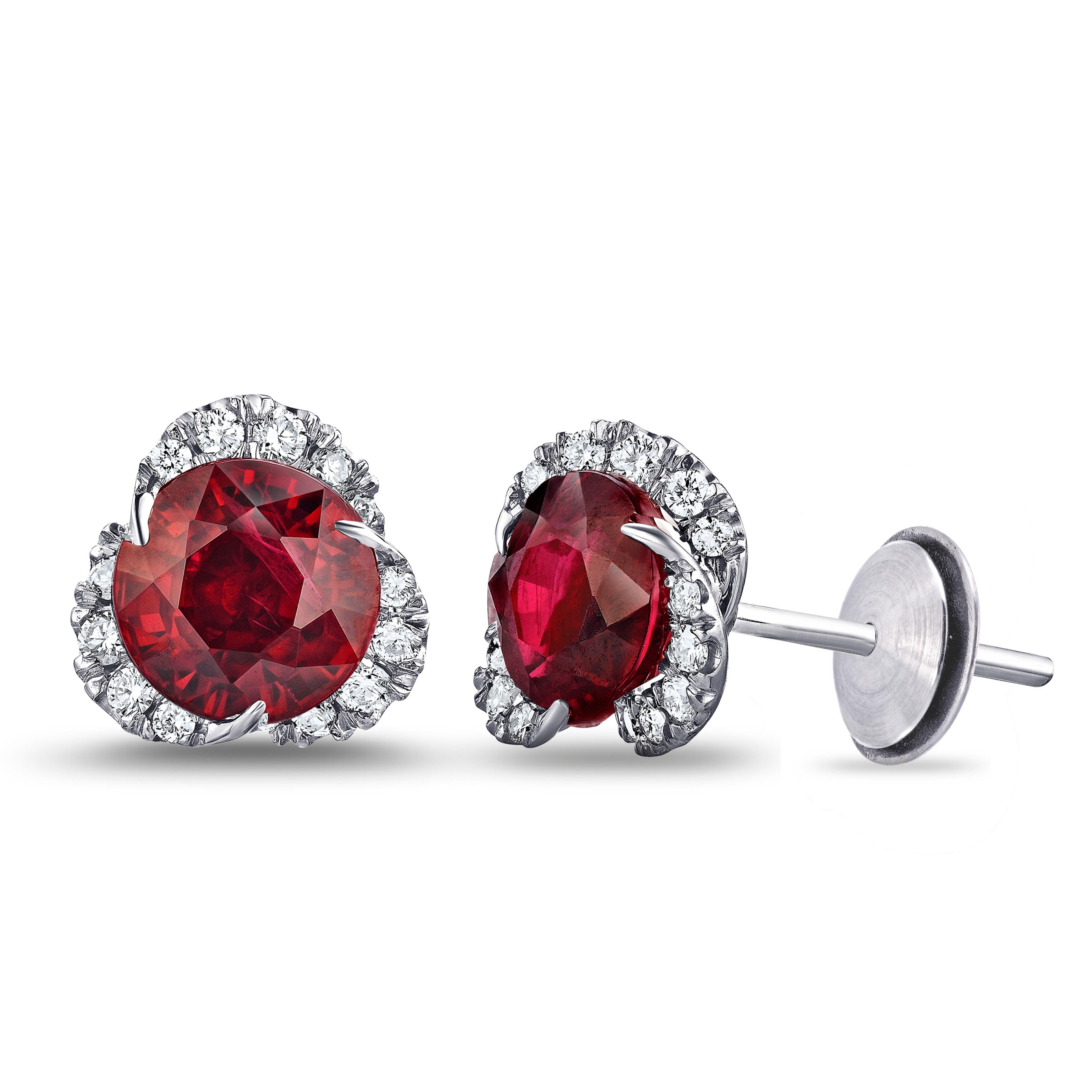 Two round red rubies weighing 2.92 carats set with 30 round diamonds weighing .38 carats (F+ VVS/VS+). Set in hand made platinum.