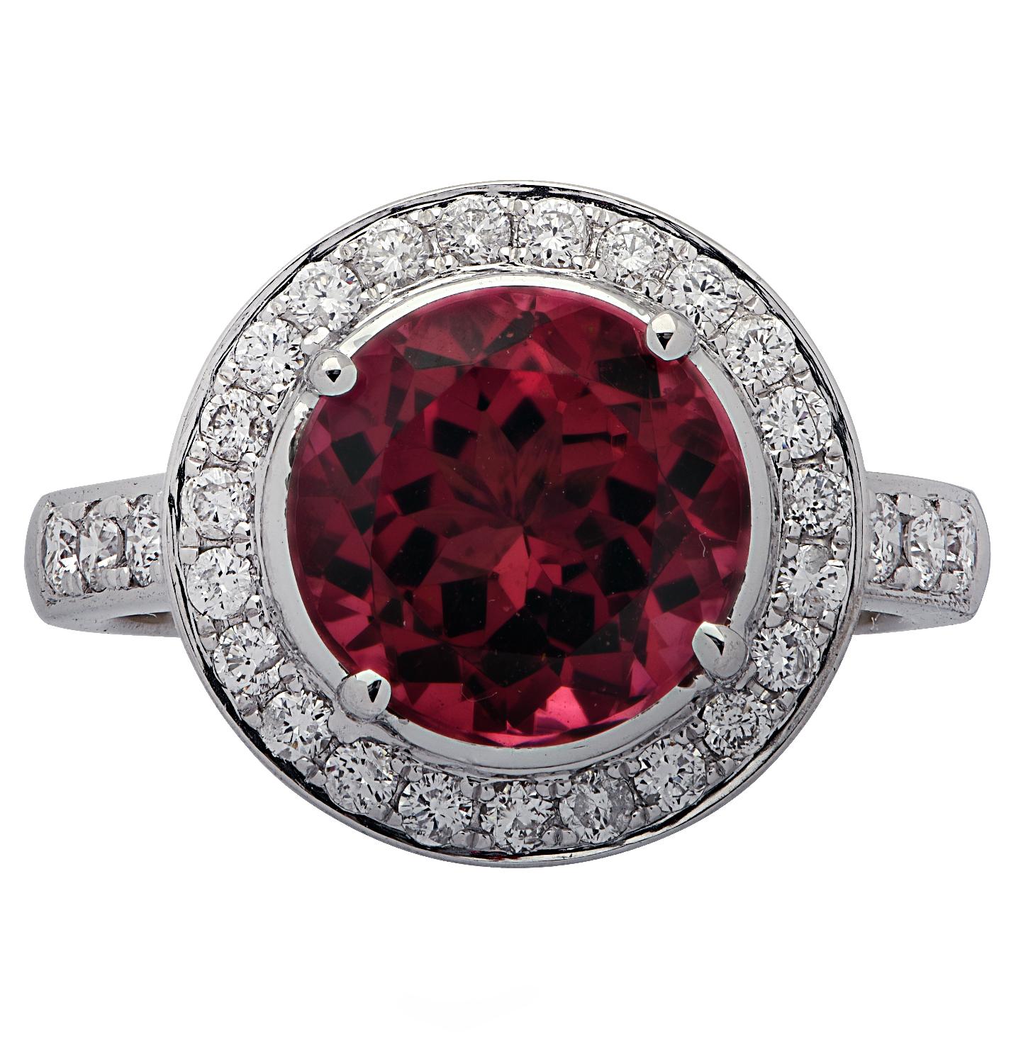 Stunning engagement ring crafted in 18 karat white gold, showcasing a round Rubellite Tourmaline weighing approximately 2.93 carats adorned with round brilliant cut diamonds weighing approximately .47carats total, G color, VS clarity. The face of