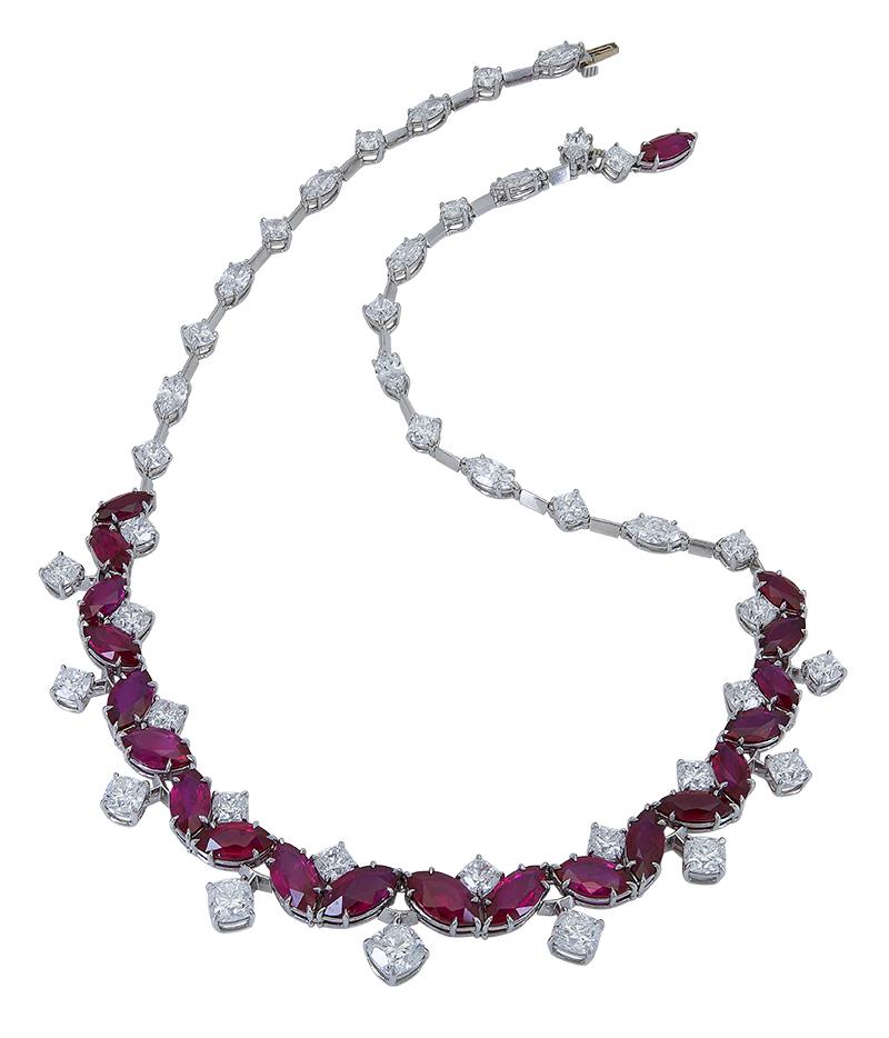 A unique style necklace showcasing marquise cut rubies set in an alternating/ V shape design. Rubies accented with cushion cut diamonds that drop and fit the crevices of the rubies. Set in platinum.
Rubies weigh 29.30 carats total.
Diamonds weigh