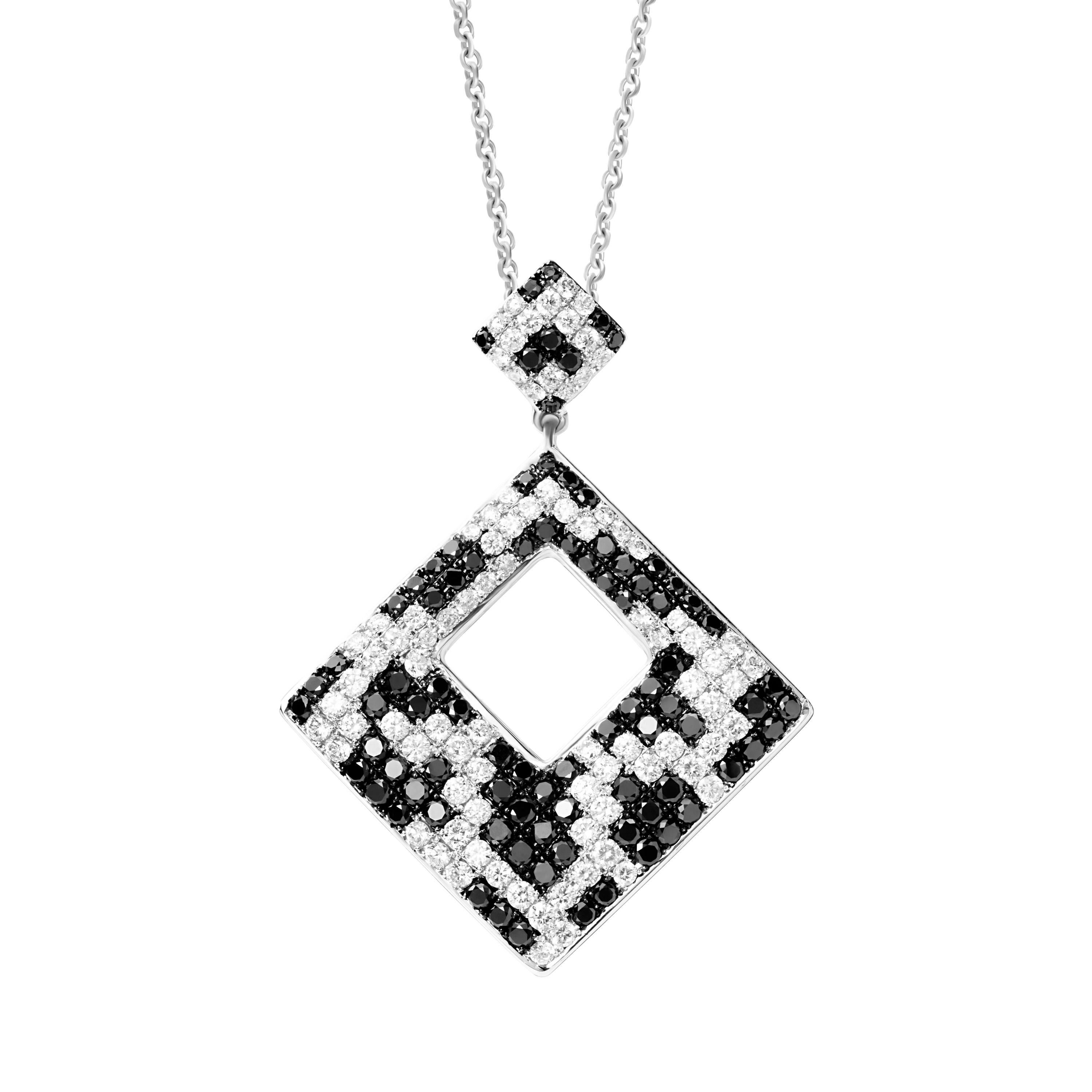 Butani's pendant necklace is cast from 18-karat white gold and set with 2.94 carats of glistening black and white diamonds.  Pendant height and width are both 3cm.  Chain length 18 inches.  

Composition:
18K White Gold
87 Round Black Diamonds 1.52