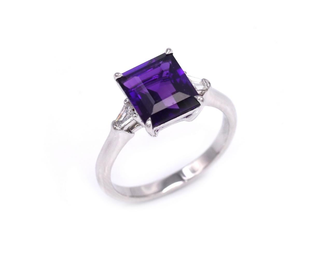 This classy elegant 18 Karat White Gold ring features a flawless purple square shaped amethyst and two diamonds. The dramatically deep purple hues of Amethyst are known to have inspired civilizations around the world for thousands of years. Amethyst
