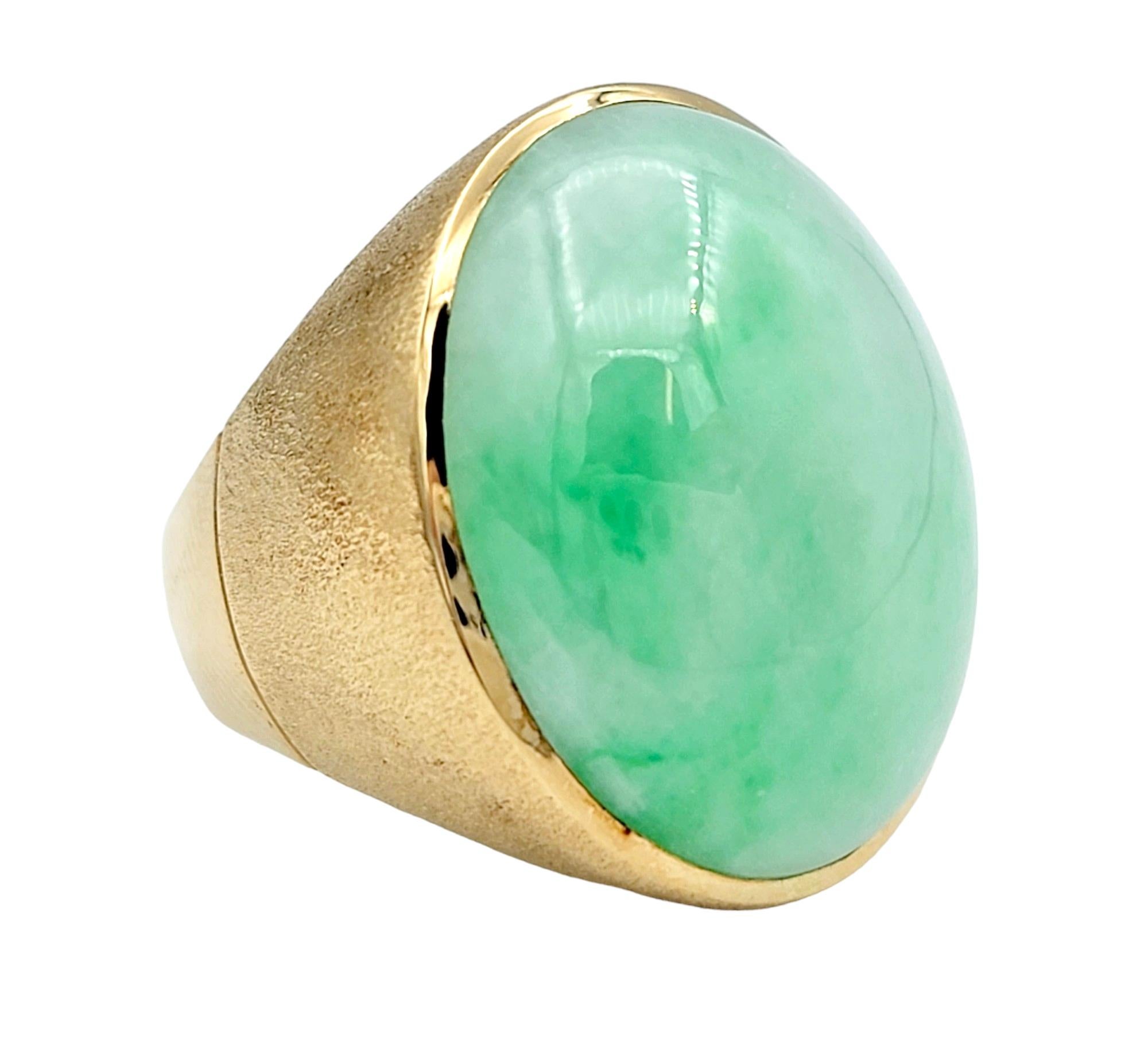 Ring Size: 7.25

This beautiful oval nephrite cabochon ring, set in 14 karat yellow gold, is a unique and elegant piece featuring the distinct beauty of nephrite, a type of jade. The smooth, polished surface of the nephrite cabochon showcases its