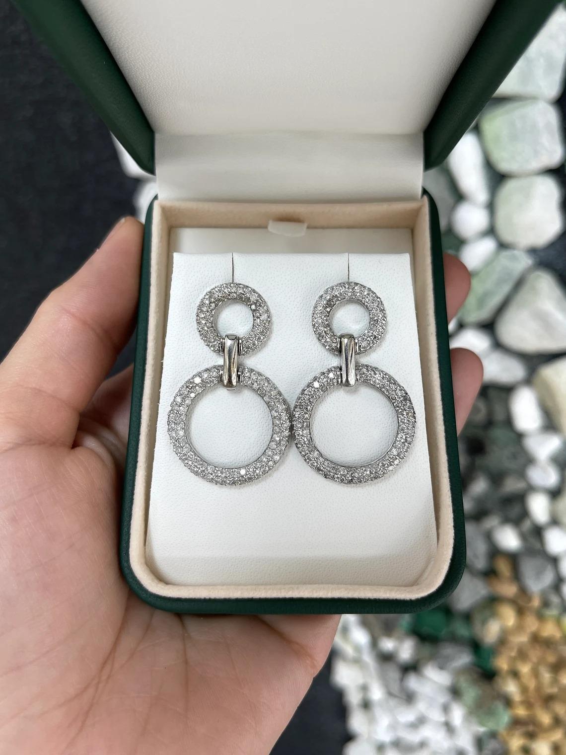 A gorgeous set of diamond drop and dangle hoop earrings. An incredibly impressive set showcasing rows of brilliant round diamonds glimmer from all angles. The earrings are lightweight and so easy to wear for an eye-catching look.

Setting Style: