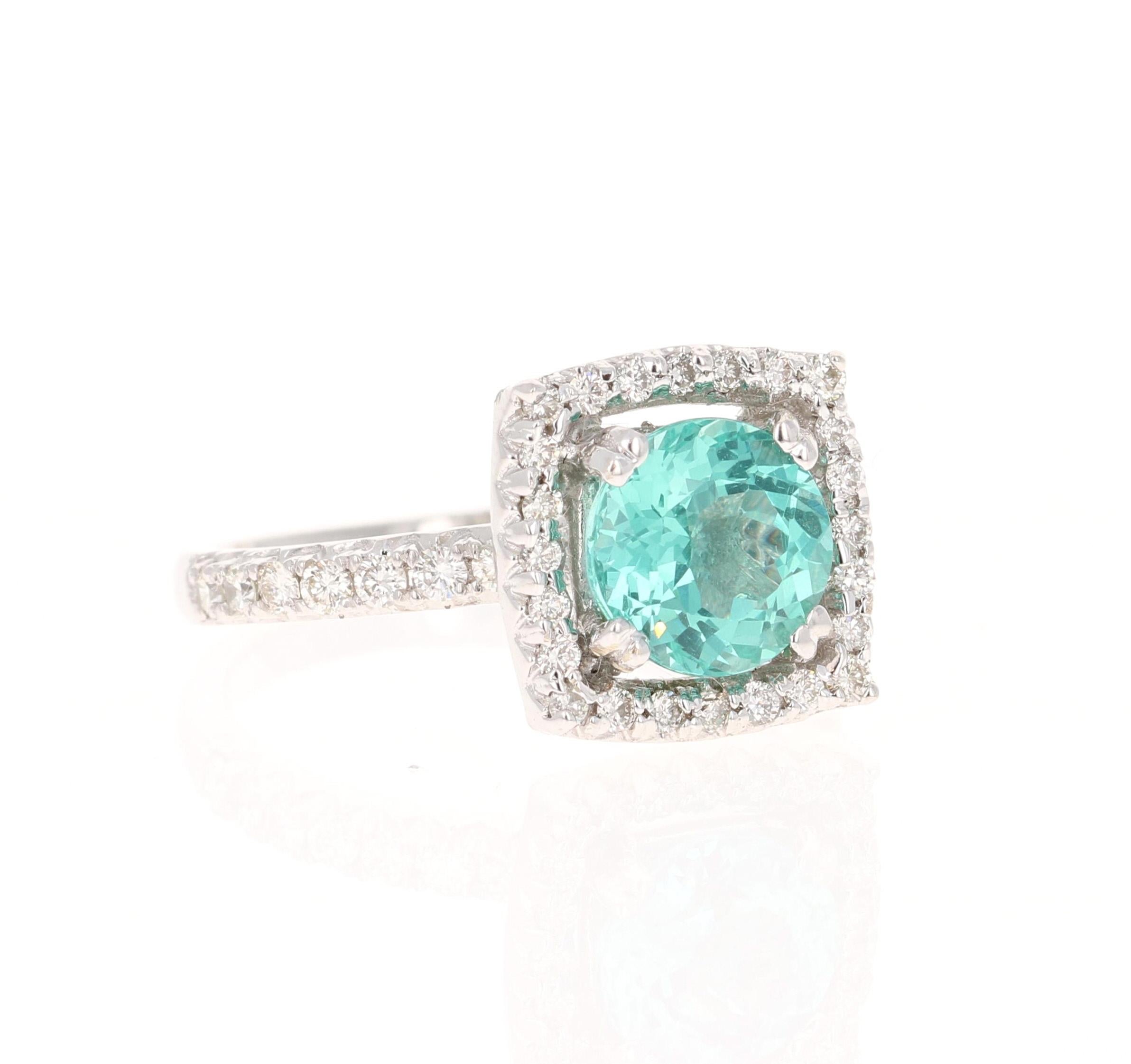 This ring has a 2.23 carat Round Cut Natural Apatite in the center of the ring and is surrounded by a halo of 56 Round Cut Natural Diamonds that weigh 0.72 carats. The clarity of the diamonds are VS and the color is H. The total carat weight of the