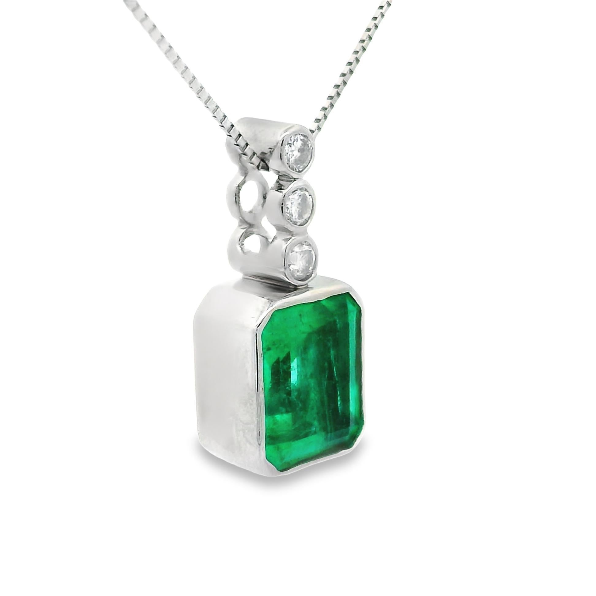 A simple yet classic emerald and diamond pendant! It features a 2.95 carat emerald-cut emerald which is bezel-set and accented by round brilliant-cut diamonds weighing 0.17 carats total. A clean and simple design that can be worn casually every day.