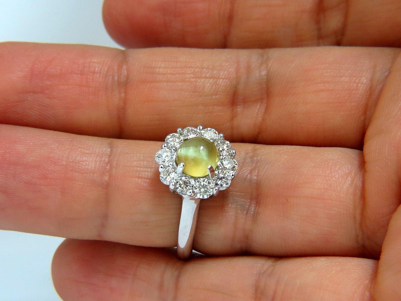1.80ct. Natural Chrysoberyl (Cats Eye) & 1.15ct. diamonds ring.

Round Cabochon, Excellent VS Clean Clarity

Brilliant Vivid Bright Yellowish Green backround and good 