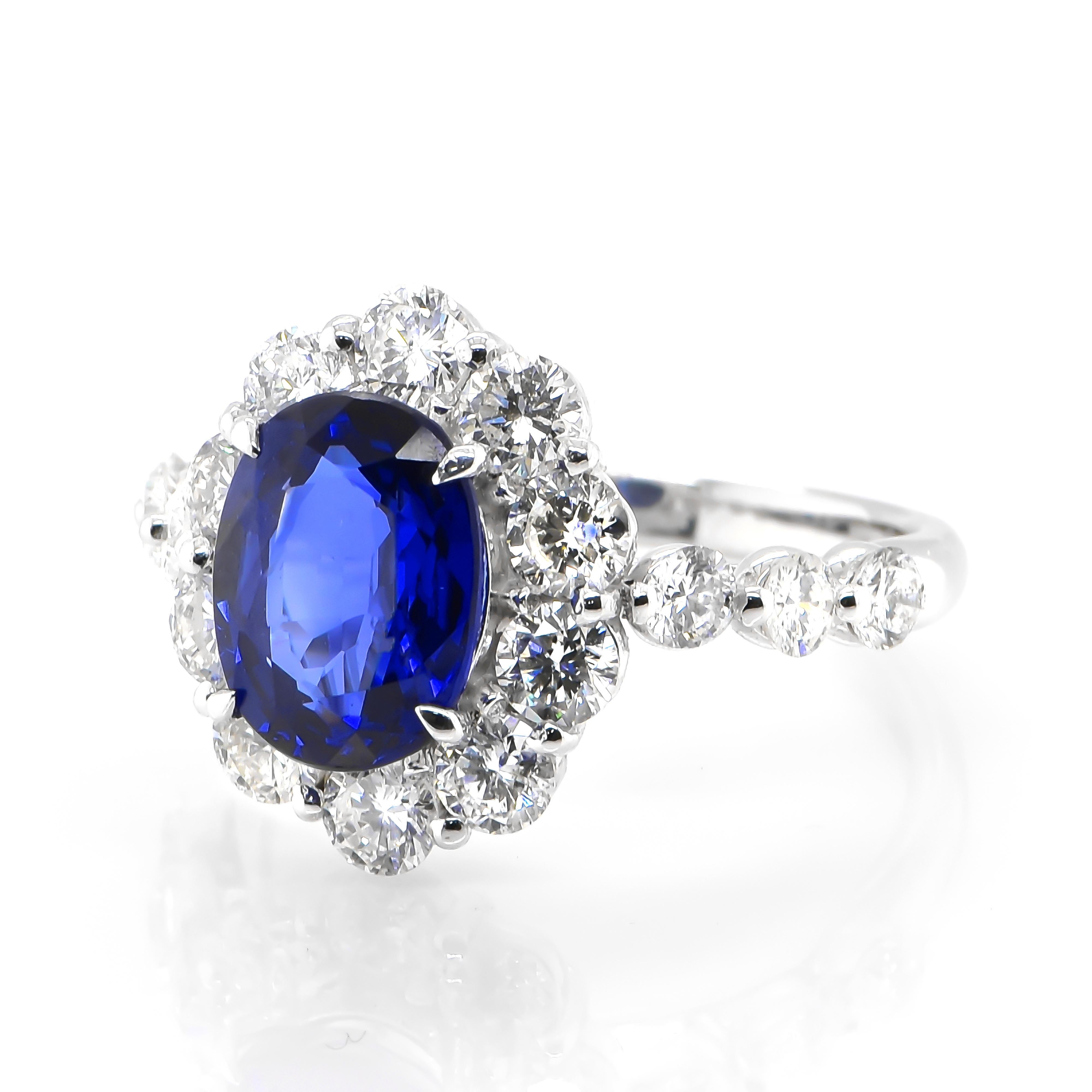 Modern 2.95 Carat Natural Royal Blue Sapphire and Diamond Halo Ring Made in Platinum For Sale