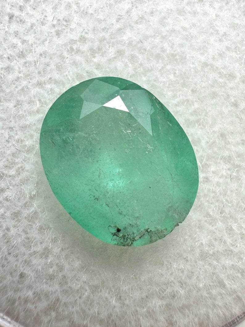 Stone: Emerald
Weight: 2.95-carats
Shape: Oval Cut
Clarity: Semi-Transparent
Luster: Good
Color: Medium Light Green
Measurements: 10.54mm x 8.64mm x 5.85mm
Geographic Origin: Colombia
Treatment: Natural, Oiling

Comments: Due to their growth