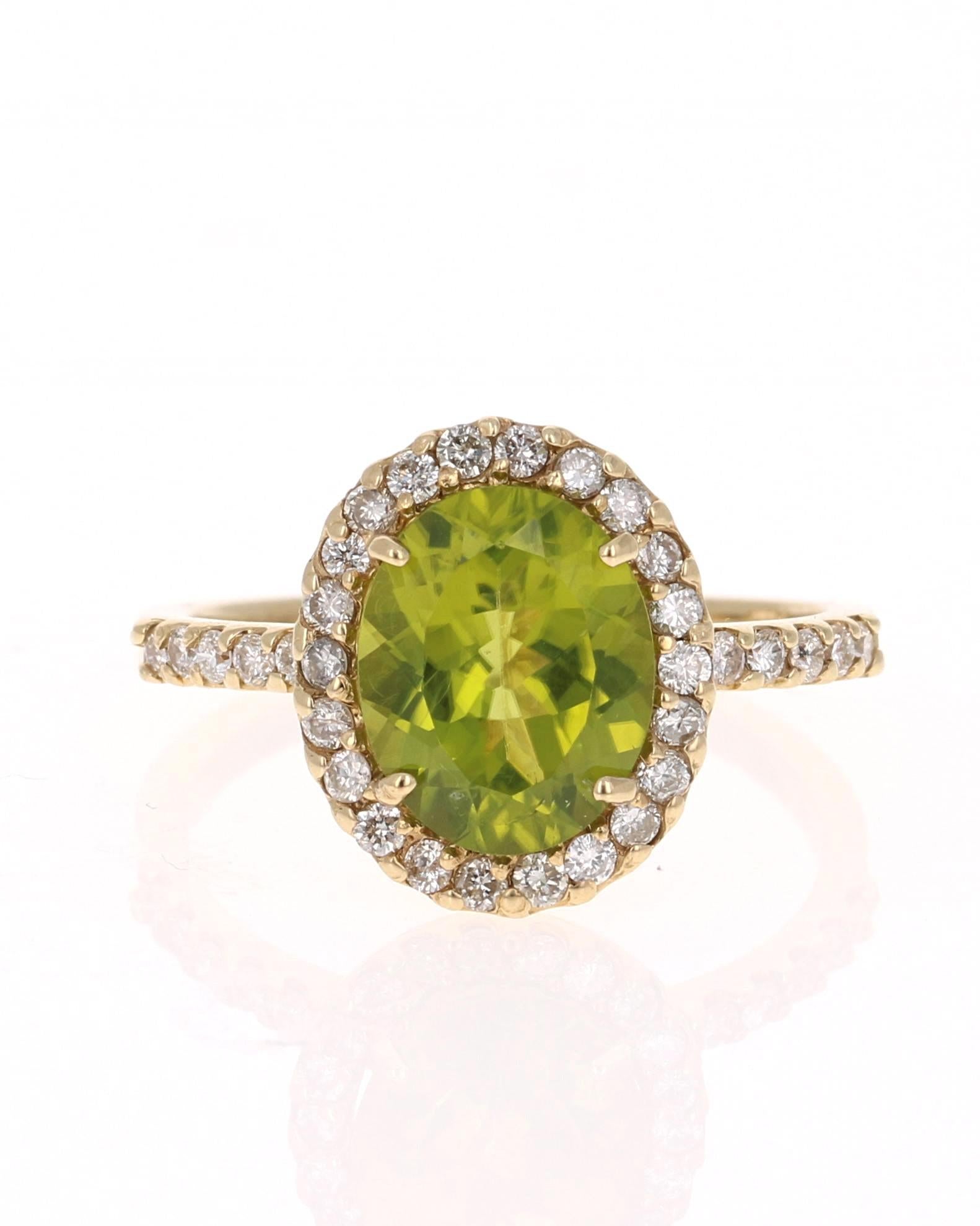 This beauty has a large Oval Cut Peridot that weighs 2.49 Carats and is surrounded by a halo of 34 Round Cut Diamonds that weigh 0.46 Carats. The total carat weight of this ring is 2.95 carats  

The ring is casted in 14K Yellow Gold and weighs