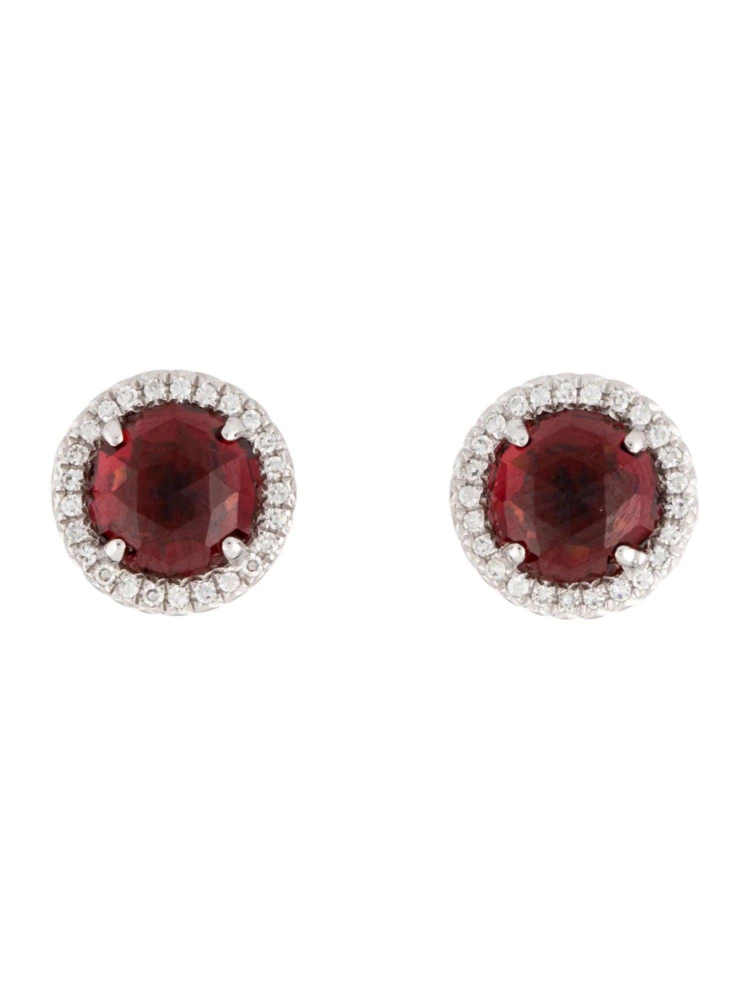 These Garnet & Diamond Earrings are a stunning and timeless accessory that can add a touch of glamour and sophistication to any outfit. 

These earrings each feature a 1.50 Carat Round Garnet , with a Diamond Halo comprised of 0.06 Carats of Single