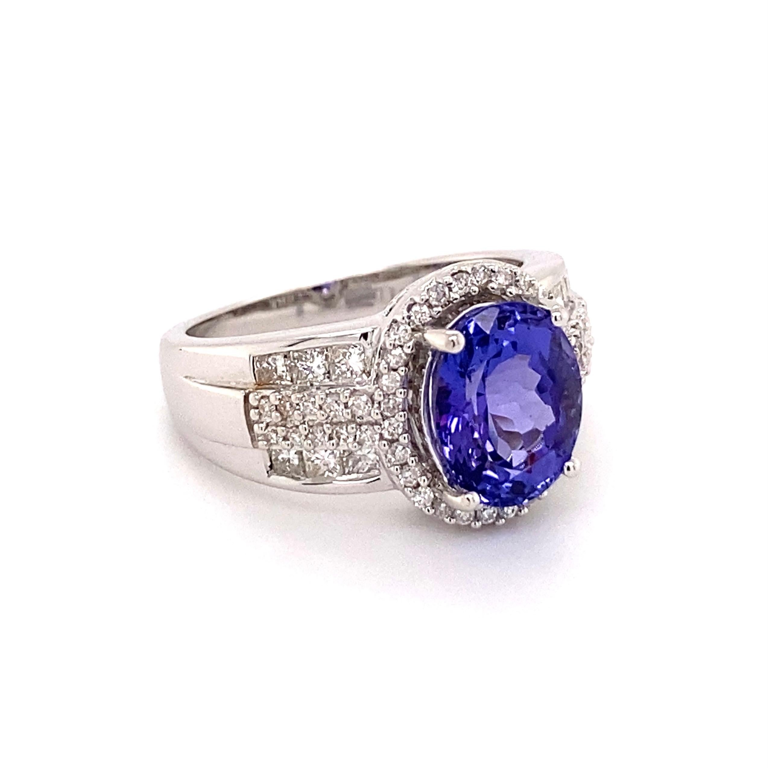 Simply Beautiful! Tanzanite and Diamond ILIANA Designer Cocktail Ring centered by an Oval 2.95 Carat Tanzanite, surrounded by Diamonds, approx. 0.59tcw. Hand crafted 18K White Gold mounting. Approx. Dimensions: 1.02” l x 0.84” w x 0.51” h. Ring size
