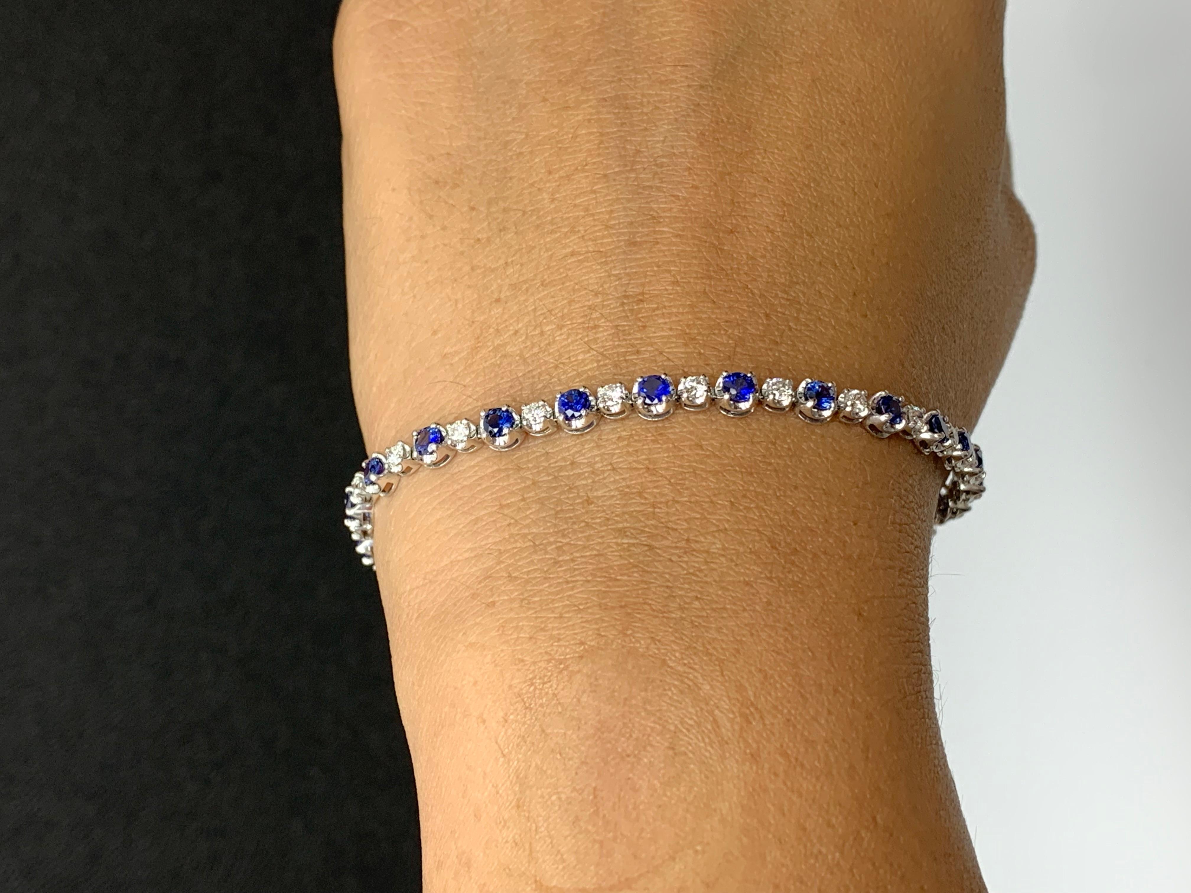 A stunning bracelet set with 23 Vibrant Blue Sapphires weighing 2.96 carats total. Alternating these blue sapphires are 25 sparkling round diamonds weighing 1.15 carats in total. Set in polished 14k white gold. Double lock mechanism for maximum