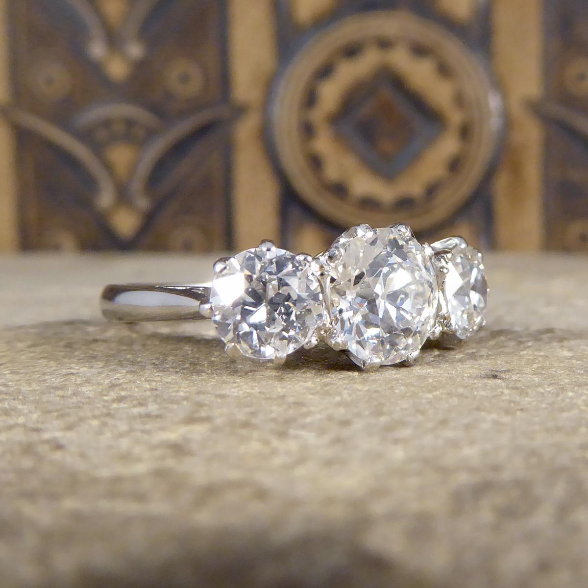 This gorgeous three stone or trilogy Diamond ring holds Old European Cut Diamonds in a contemporary setting. The trilogy diamond ring became a very popular style in the 1920/30's demonstrating how this style stands the test of time. Set in onto an