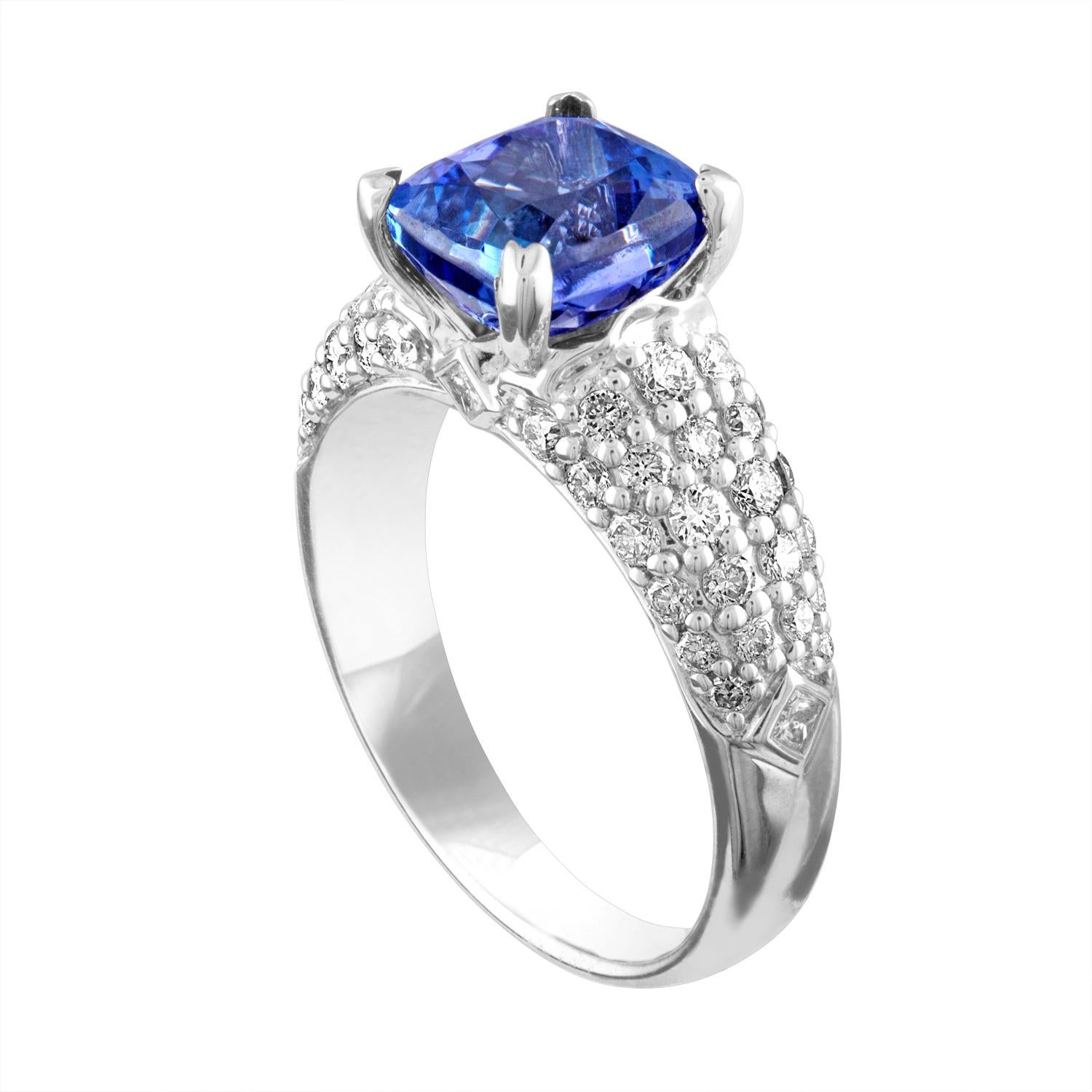 Beautiful Pave Ring
The ring is 18K White Gold
The Center Stone is a Cushion Cut Tanzanite 2.97 Carats
There are 0.99 Carats in Diamonds F/G VS/SI
The ring is a size 6.50, sizable
The ring weighs 5.3 grams