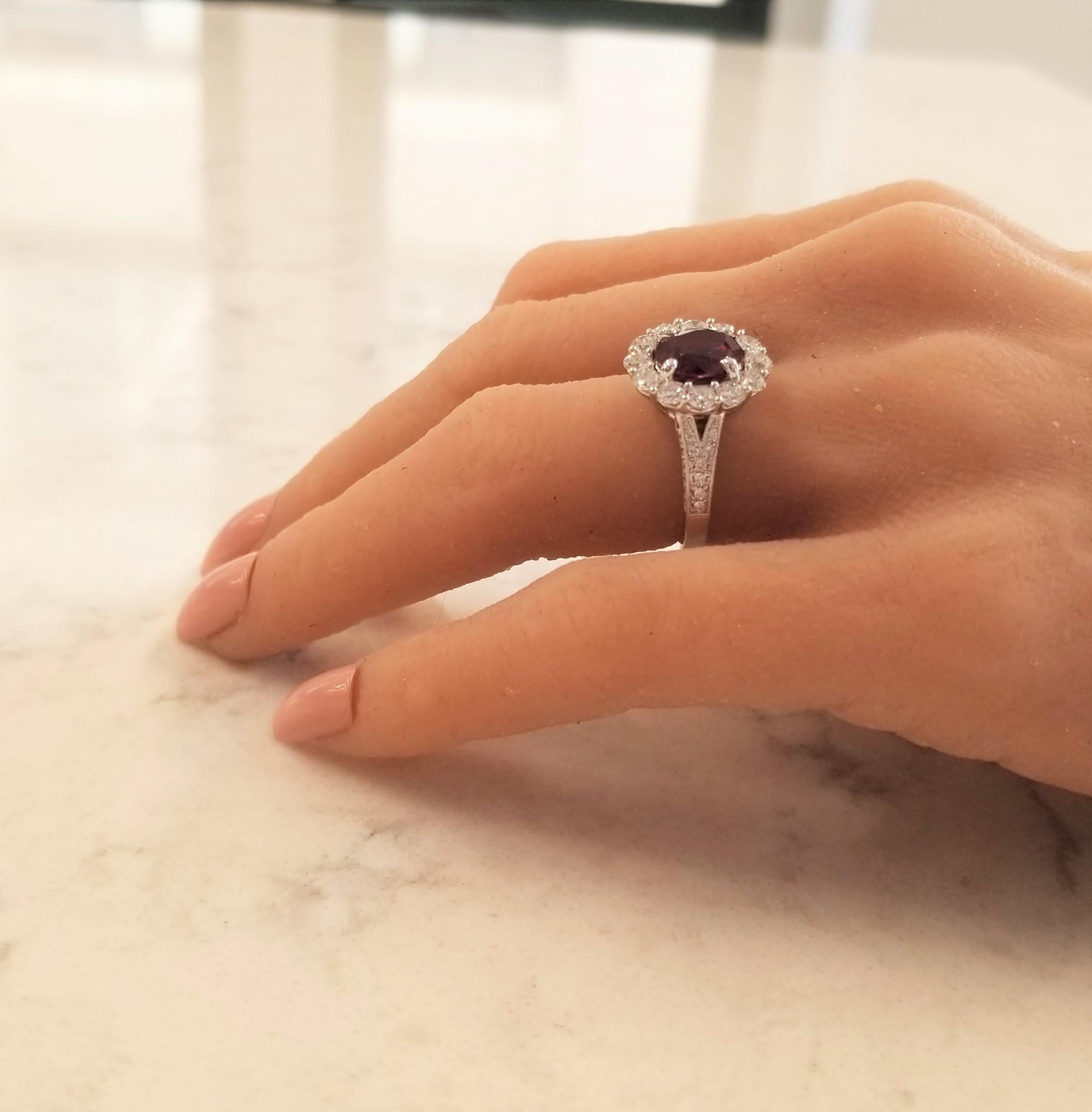 This sapphire ring isn't just as unique as it looks, it stands out from all other purples on the spectrum. This gem source is Sri Lanka; the cut is an oval brilliant; the color is unique to a deep vivid purplish-pink with undertones of berry hues