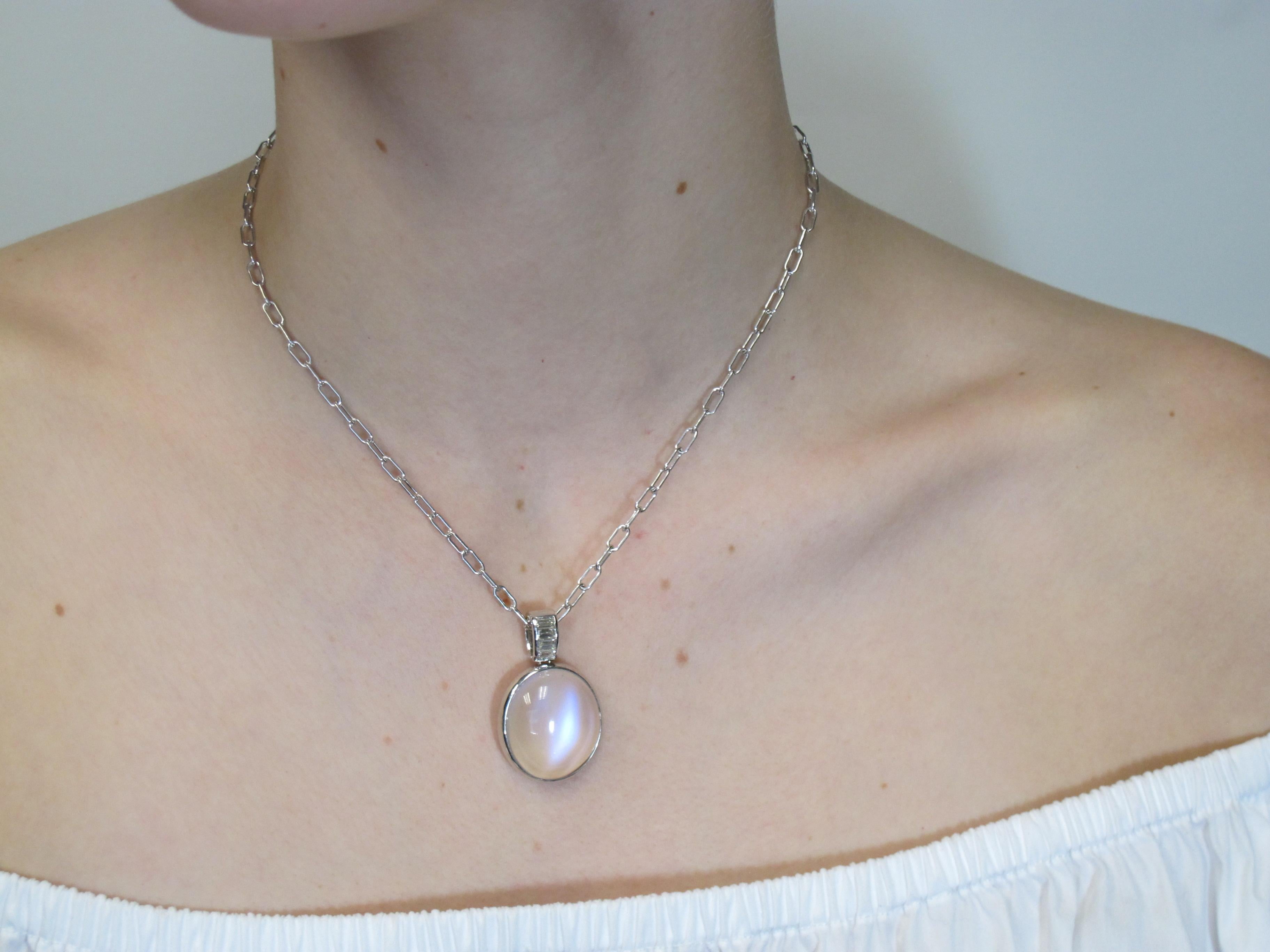 This handmade, 18k white gold pendant features an unusually large, gem-quality moonstone set with beautiful baguette cut diamonds. This moonstone is highly transparent and possesses gorgeous 