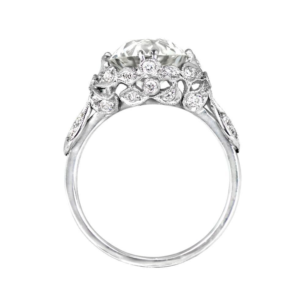 Experience the elegance of the Edwardian era with this platinum ring, featuring a 2.97 carat old European cut diamond in prong setting, with I color and VS1 clarity. The exquisite design showcases diamond-set floral and bow motifs that gracefully