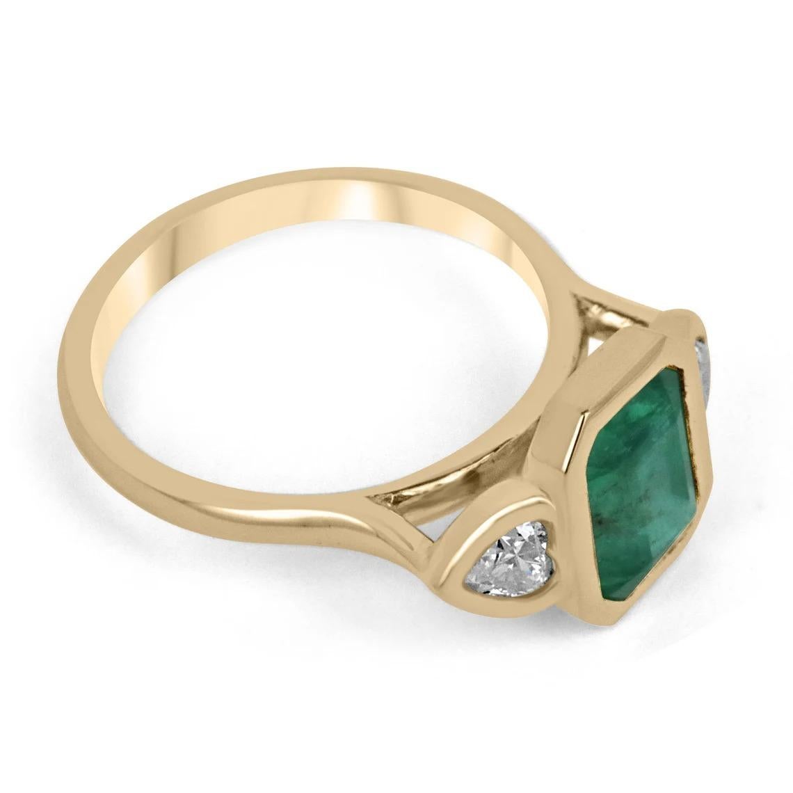 Shower her with love with this emerald and diamond heart cocktail ring. Dexterously handcrafted in gleaming 18K yellow gold, this ring features a 2.57-carat natural emerald, emerald cut. Set in a secure bezel setting for extra protection. This