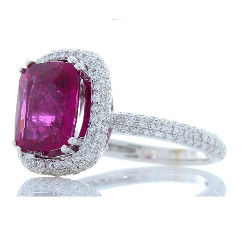 Everything about this raspberry-hued rubellite ring exudes richness, starting with the illuminating 2.98 carat – 10.77 X 8.72 millimeter vivid rubellite. The gem source is Brazil and displays notes of pink, purple, red, and stunning light