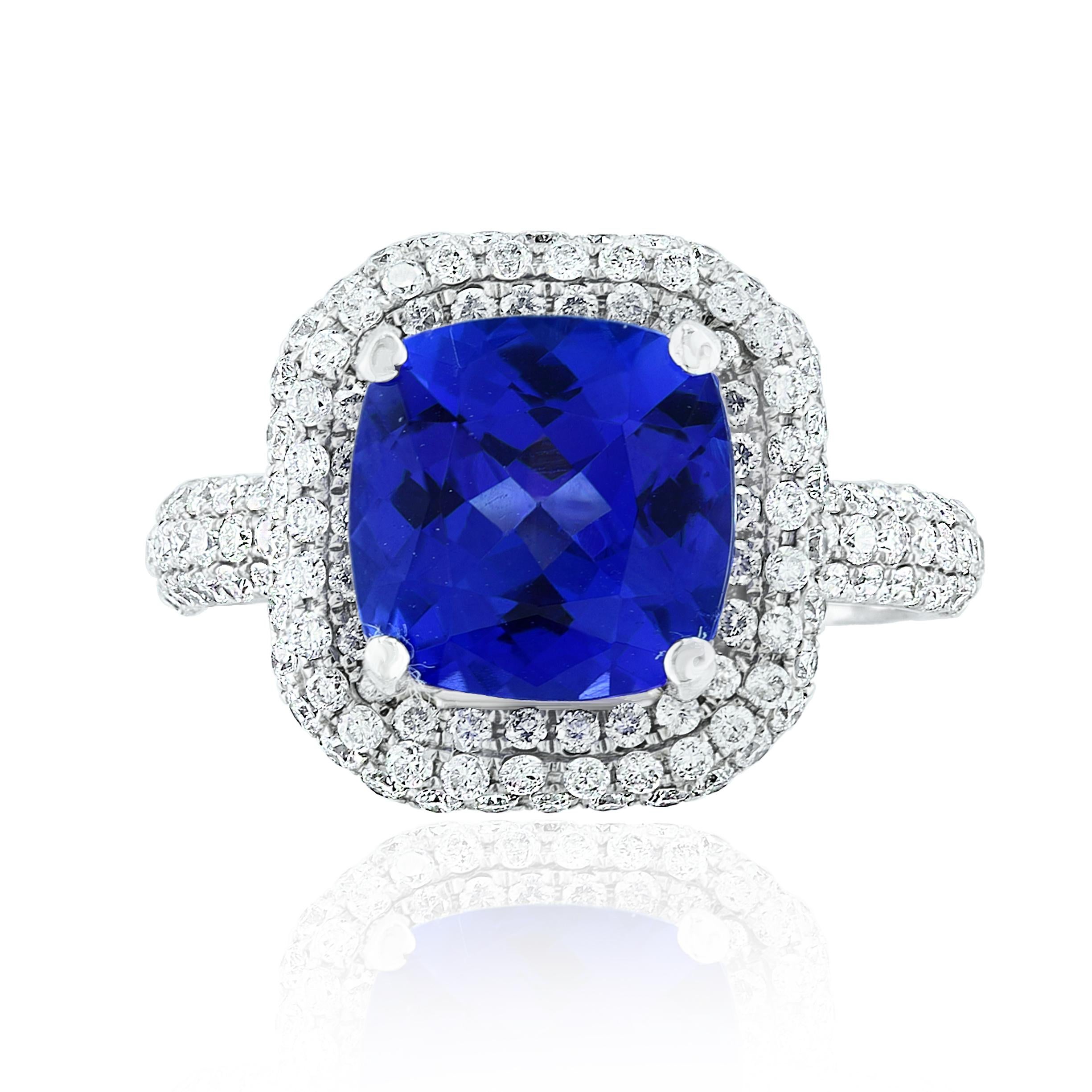 2.98 Carat Cushion Shape vibrant Tanzanite and Diamond Cocktail Ring in 18K White Gold. The Center stone is surrounded by 2 rows of 154 Brilliant cut Round Diamonds with a Total weight of 0.98 carats of total weight. 
A classic Cocktail Ring full of