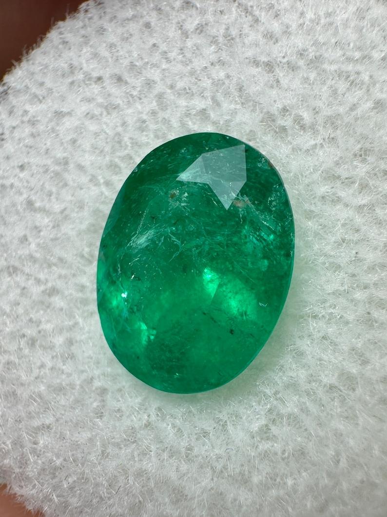 Stone: Emerald
Weight: 2.98-carats
Shape: Oval Cut
Clarity: Transparent
Luster: Very Good
Color: Intense Dark Green
Measurements: 10.60mm x 8.26mm x 6.29mm
Geographic Origin: Colombia
Treatment: Natural, Oiling

Comments: Due to their growth