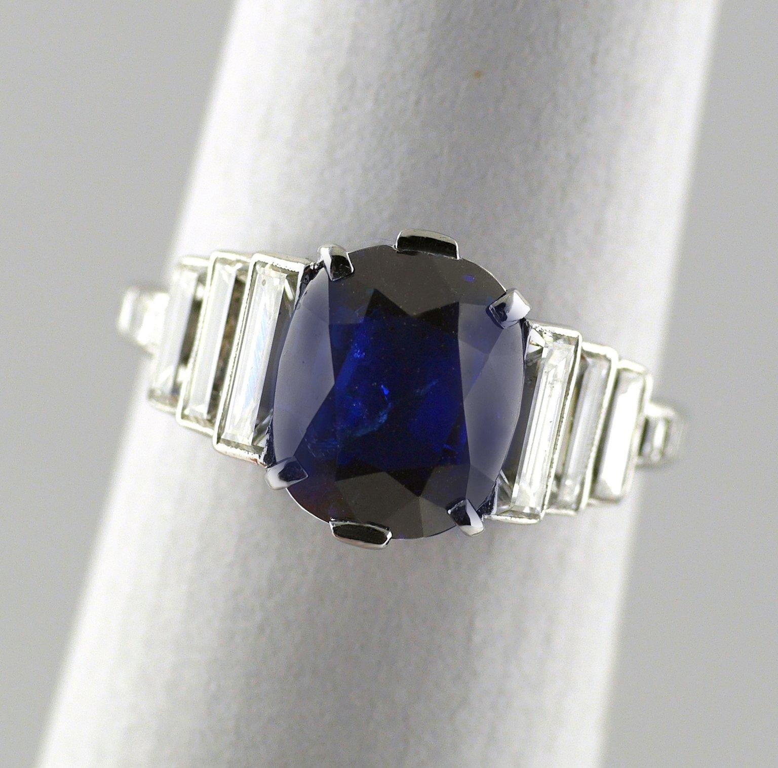 Natural colour, untreated, 2.99 carat sapphire and diamond Art Deco Platinum ring circa 1930.

With three stepped baguette diamonds on each shoulder F/G/H, Vs1, total weight approx 1.0ct. Gemmological Certification Services Certificate.

Art