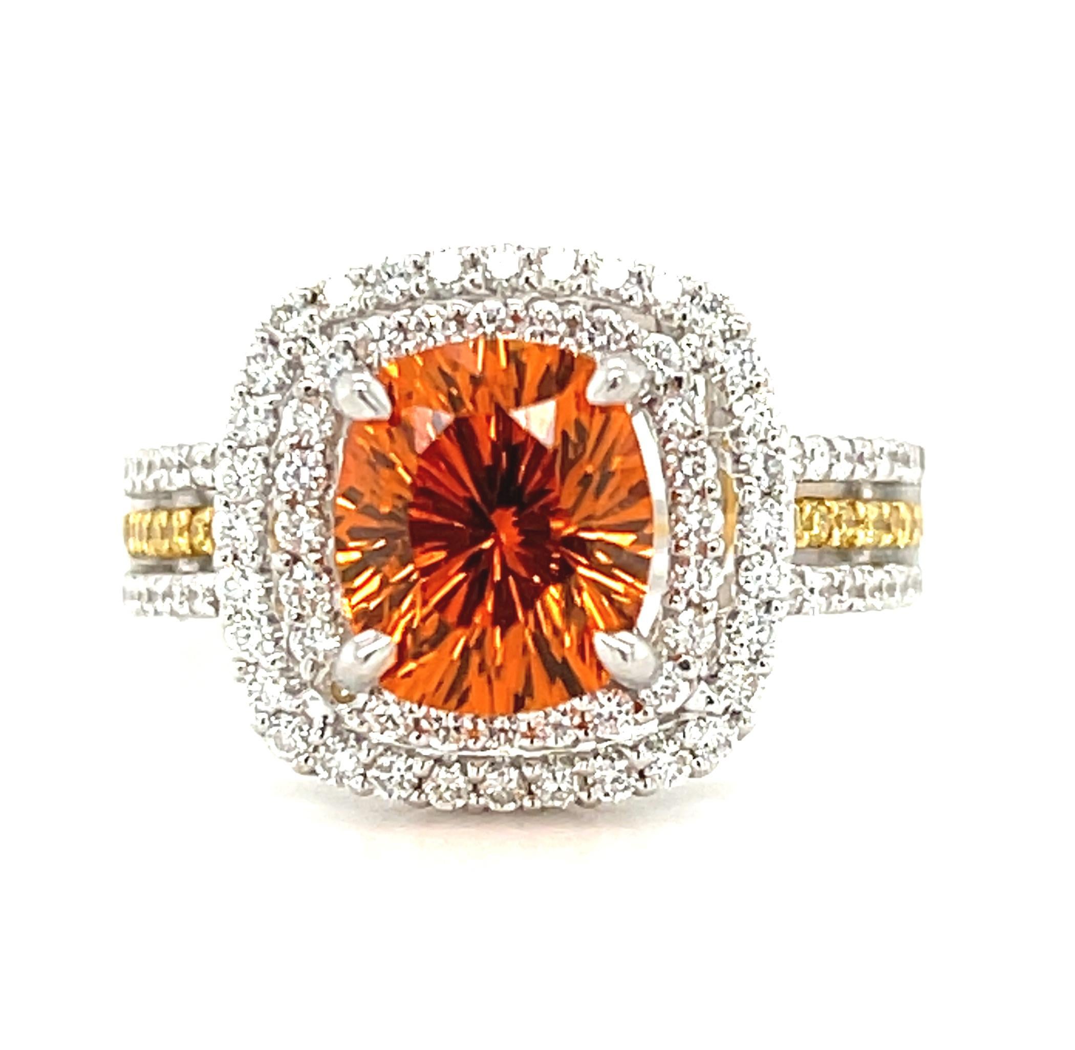This sparkling cocktail ring features a gorgeous cushion shaped, orange spessartite garnet with spectacular brilliance and life! Weighing 2.99 carats, this top quality, unusual gem has been faceted with a fancy starburst pavilion (or bottom), giving