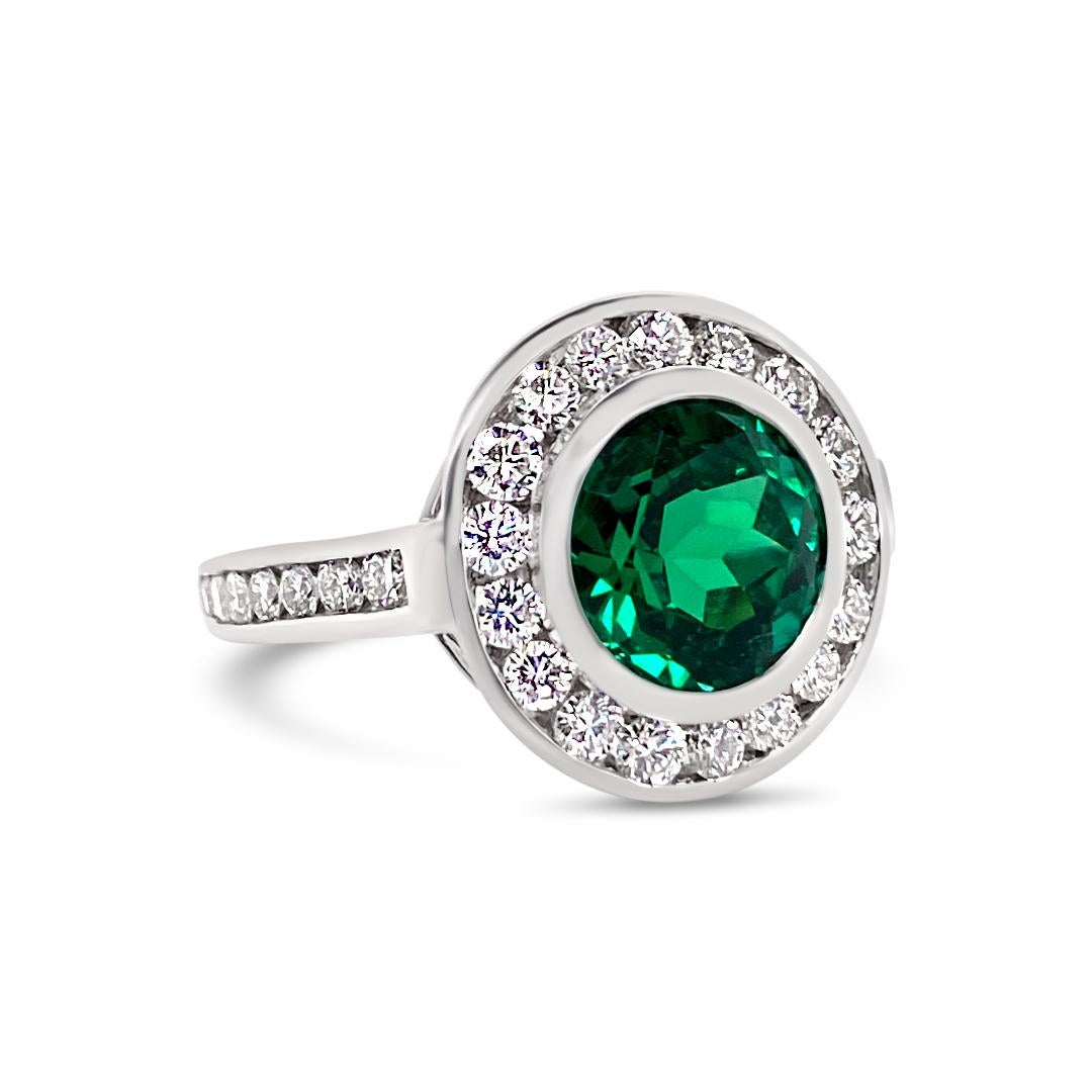 2.99 Carats Vivid Green Emerald Bezel Set with 1.14 Carats of Diamond accents. Set in Platinum.
 
