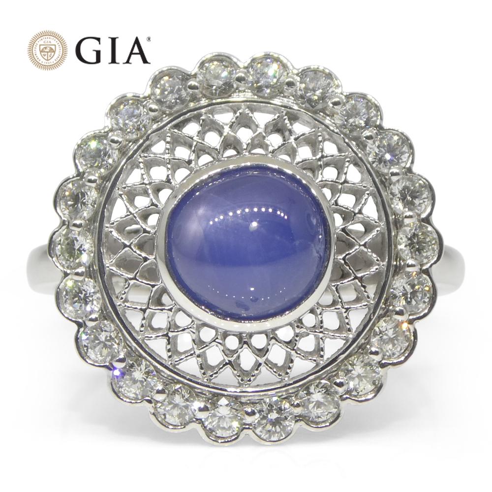 Discover the timeless beauty of this exquisite engagement ring, featuring a GIA Certified 2.99-carat Round Blue Star Sapphire complemented by a halo of sparkling diamonds. Handcrafted in luxurious 18k white gold, this ring is a perfect blend of