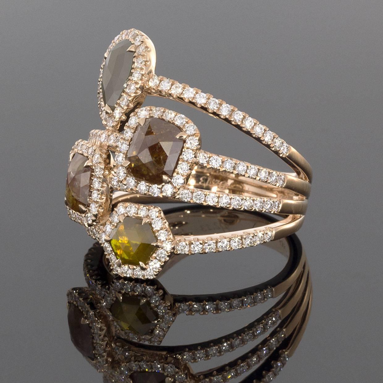 This gorgeous four-stone halo ring is sure to wow!  This ring features four uniquely faceted diamonds in shades of gray, green, red and yellow. Each diamond is surrounded by a halo of white round diamonds. The diamonds have a total weight of 2.99