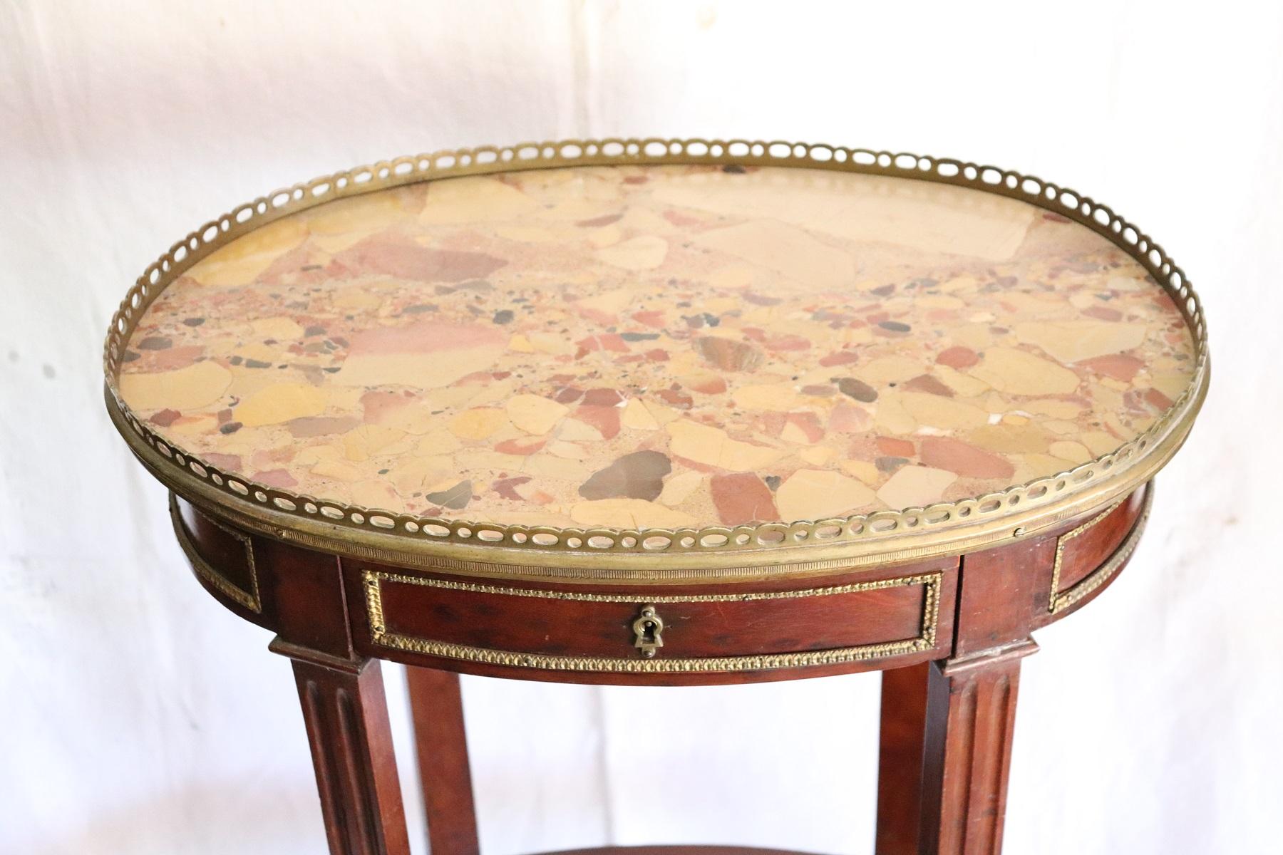 Rare and fine quality Napoleon III side table. The table has a particular legs slender. Precious mahogany wood with finely chiseled gilded bronze decorations. Fine marble top. On the front a small and practical drawer. The table is decorated on each