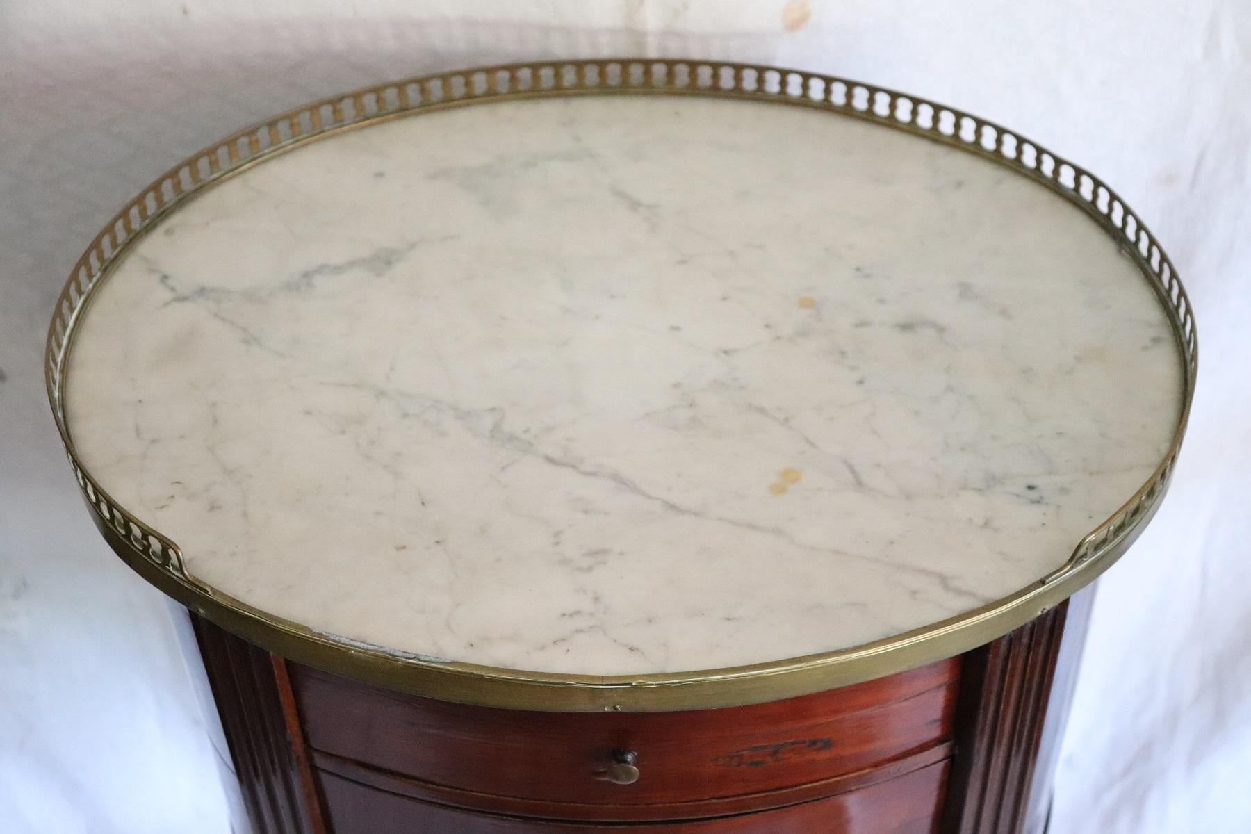 Rare and fine quality napoleon III side table. The table has a particular legs slender. Precious mahogany wood with finely gilded bronze decorations. Fine white marble top. On the front a small and practical three drawers. The table is decorated on
