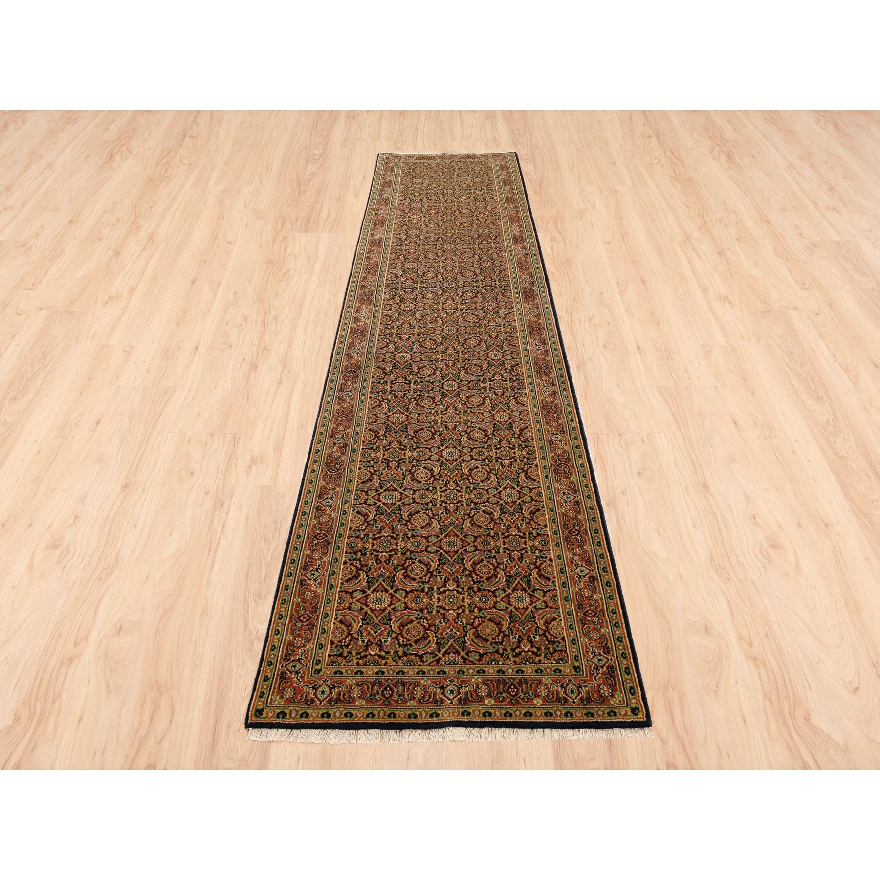 This is a truly genuine one-of-a-kind Jet Black Herati All Over Fish Design Dense Weave Hand Knotted 250 KPSI Wool Oriental Runner Rug. It has been Knotted for months and months in the centuries-old weaving craftsmanship techniques by expert
