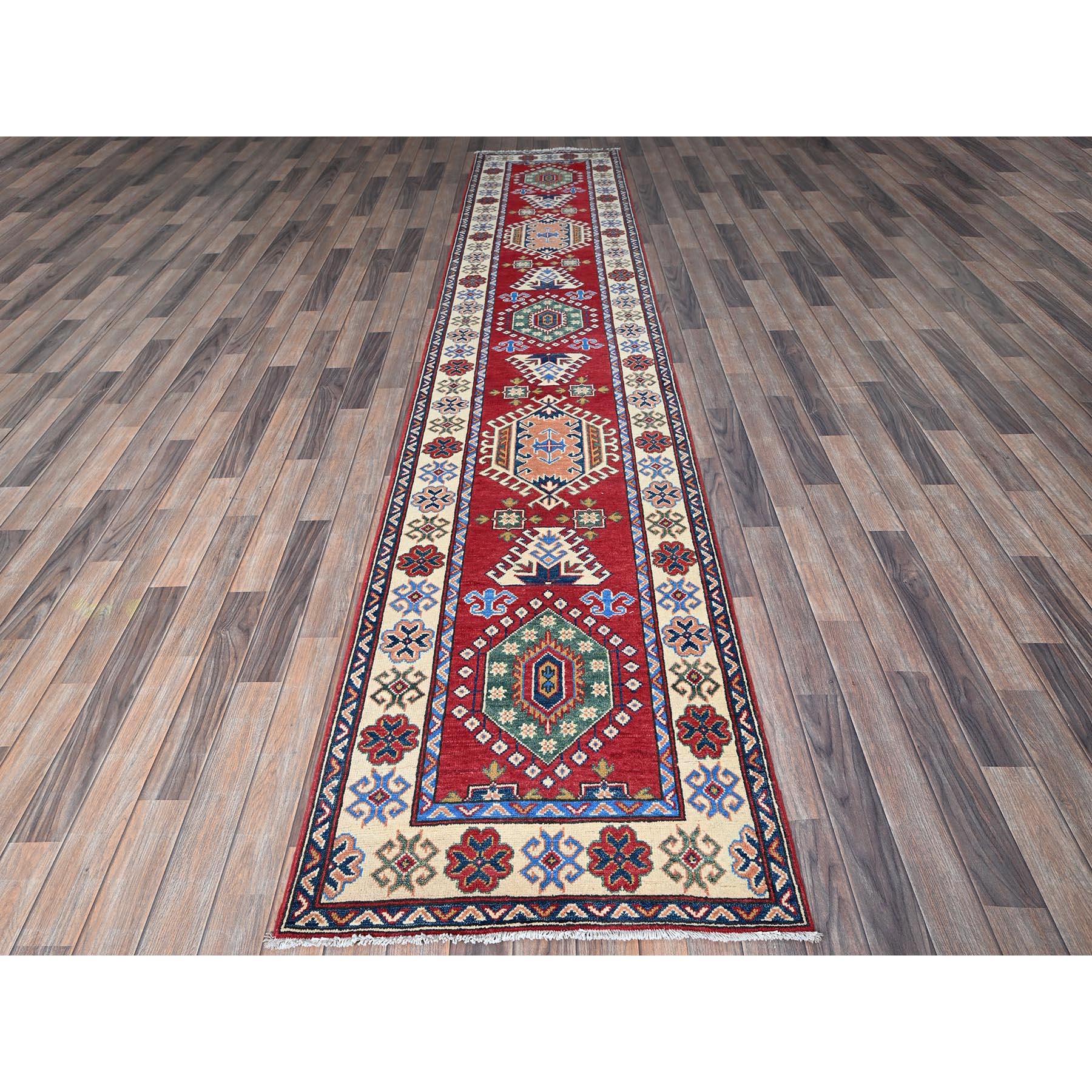Scharlachrot, Kazak mit Stammesmedaillons Design, handgeknüpft, weiche und samtige Wolle, dichtere Webart, pflanzliche Farbstoffe, Läufer, Orientteppich
Primäre MATERIALIEN: Wolle
Latex: Kein Flor 
Höhe: 0,25 Zoll
Stil: Traditionell
Grundfarbe: