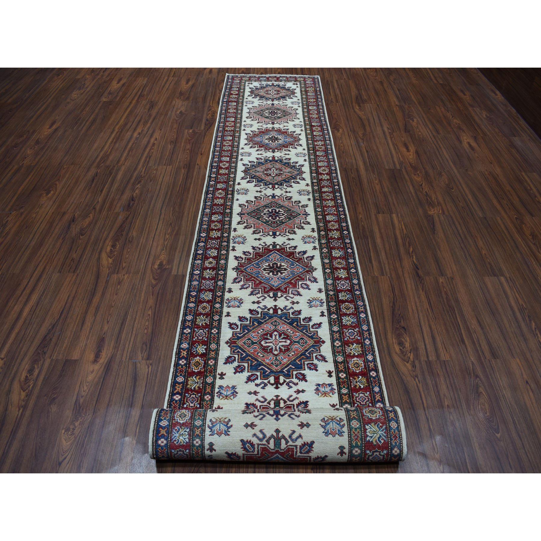 This is a truly genuine one-of-a-kind Ivory Super Kazak Geometric XL Runner Hand-Knotted Oriental Rug. It has been Knotted for months and months in the centuries-old Persian weaving craftsmanship techniques by expert artisans.
Primary materials: