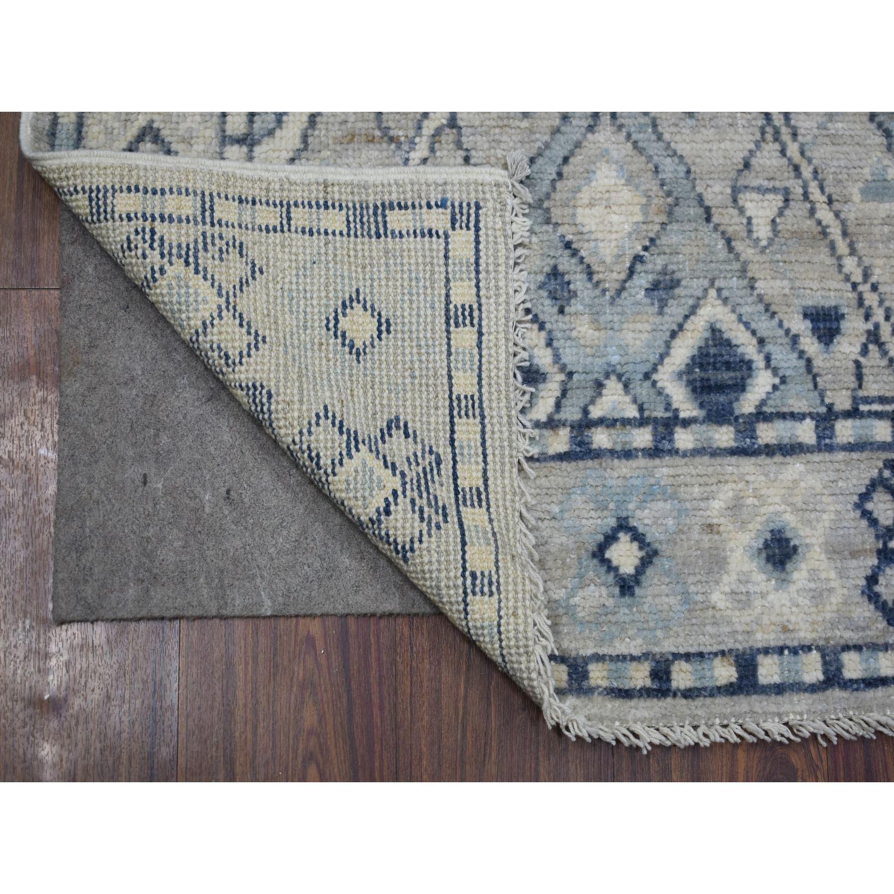 Il s'agit d'un véritable tapis d'Orient gris, en laine extra-douce, d'inspiration villageoise anatolienne avec un motif de croix croisée, noué à la main. Il a été noué pendant des mois et des mois selon les techniques artisanales de tissage
