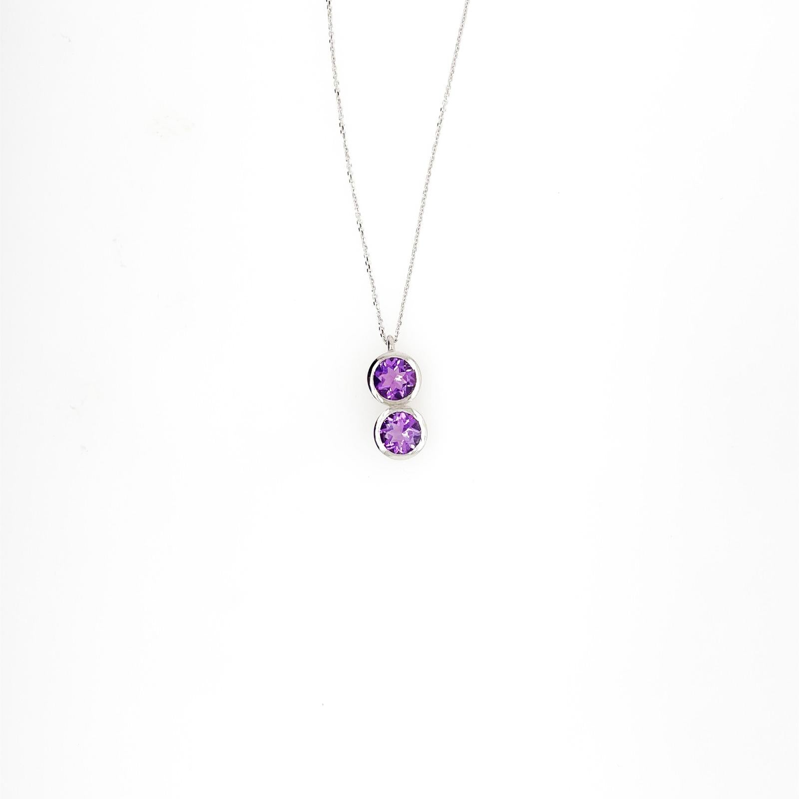 2 X 1ct round brilliant cut amethyst
= 2ct total

Bezel set 
18ct white gold (available in rose, yellow gold and platinum at request*)
solid gold pendant
Toi e moi style

This piece is custom made to order.

Available in multiple other gemstones