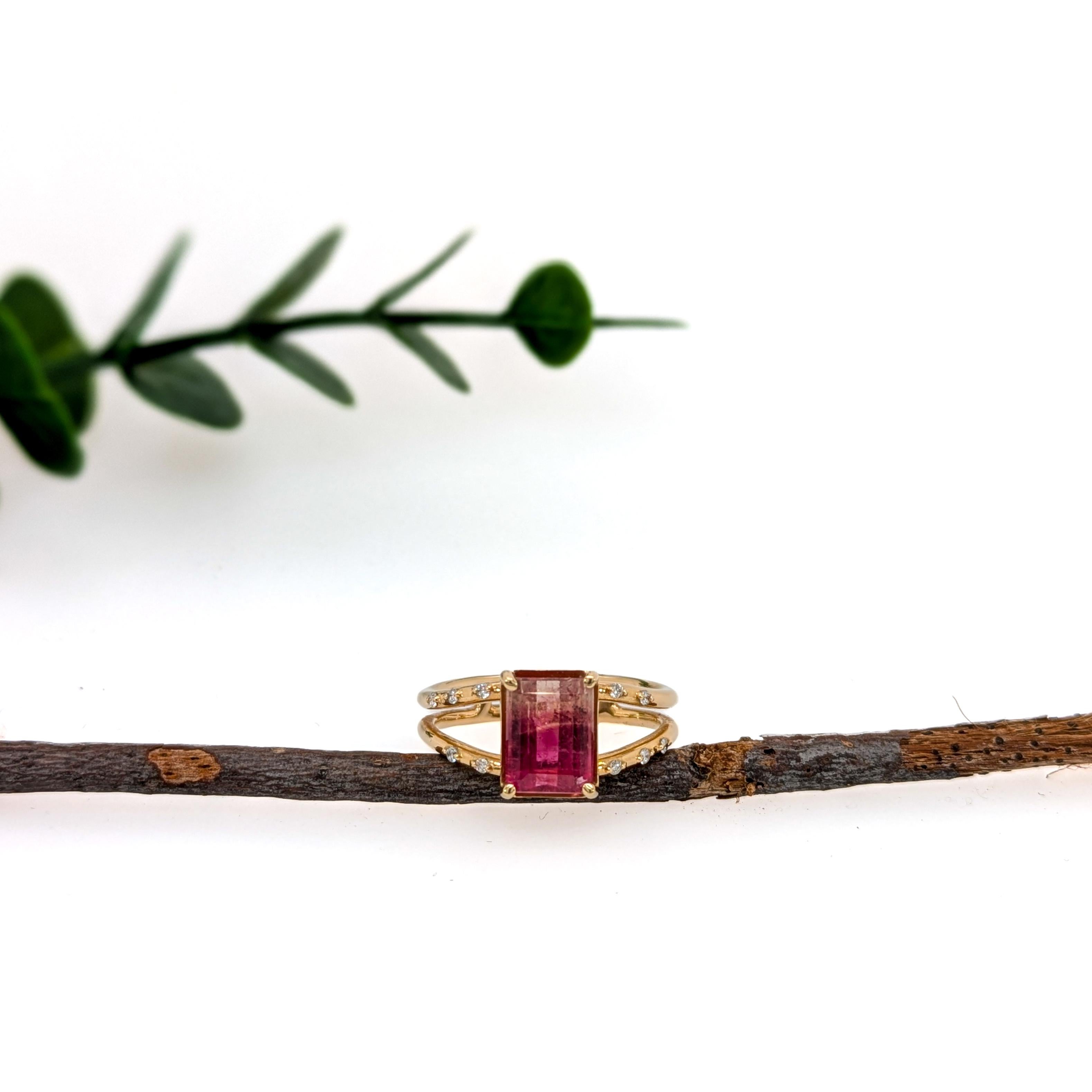 Be the first to own this brand new NNJ ring design! A gorgeous split shank natural earth mined diamond studded ring featuring a beautiful pink and white bi-color tourmaline set in solid 14k yellow gold. A gorgeous modern look that's perfectly