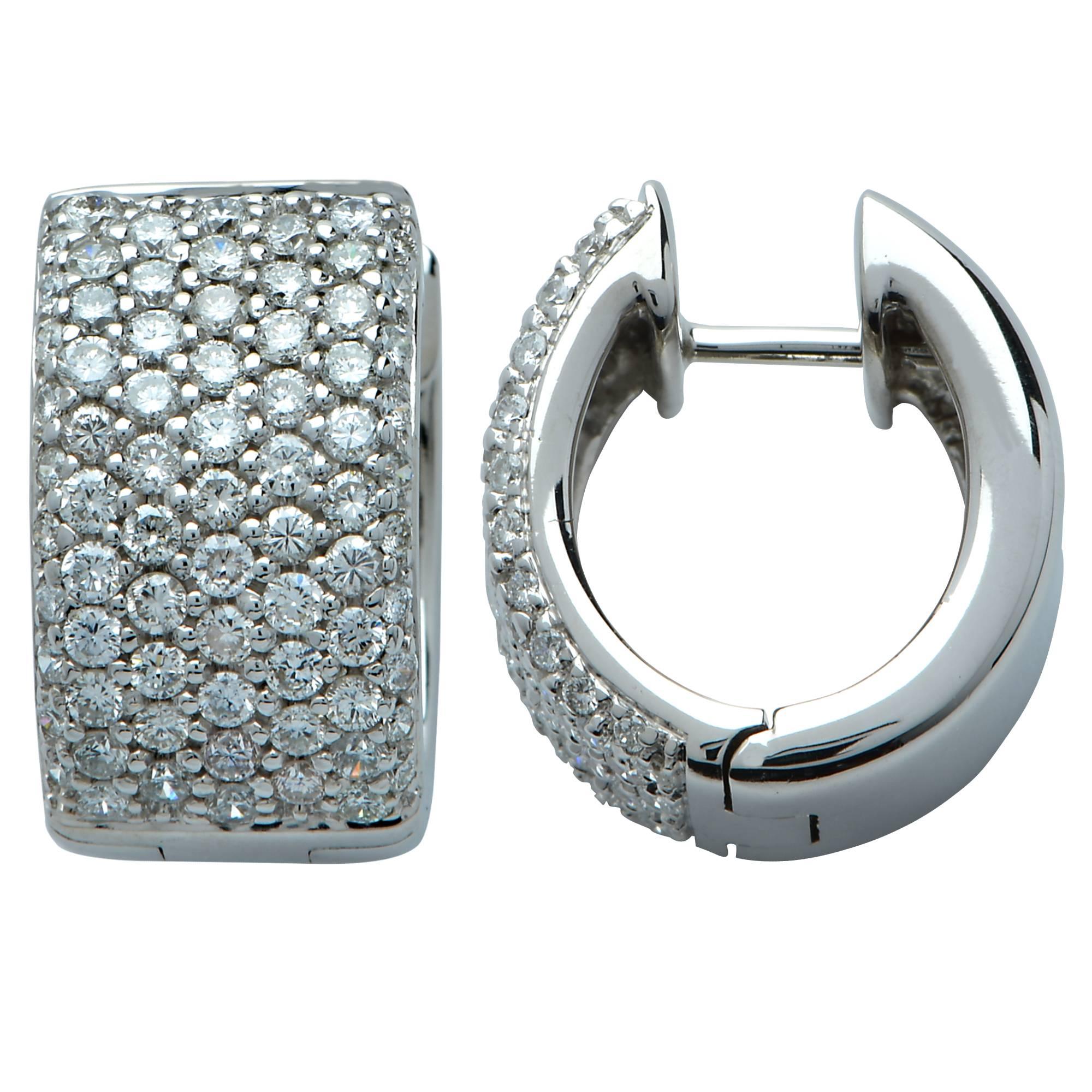 Spectacular 18K white gold earrings showcasing a dazzling display of 146 round brilliant cut diamonds weighing approximately 2cts G color and VS-SI clarity. These gorgeous huggie earrings lay close to the ear and are not only stunning, but wearable