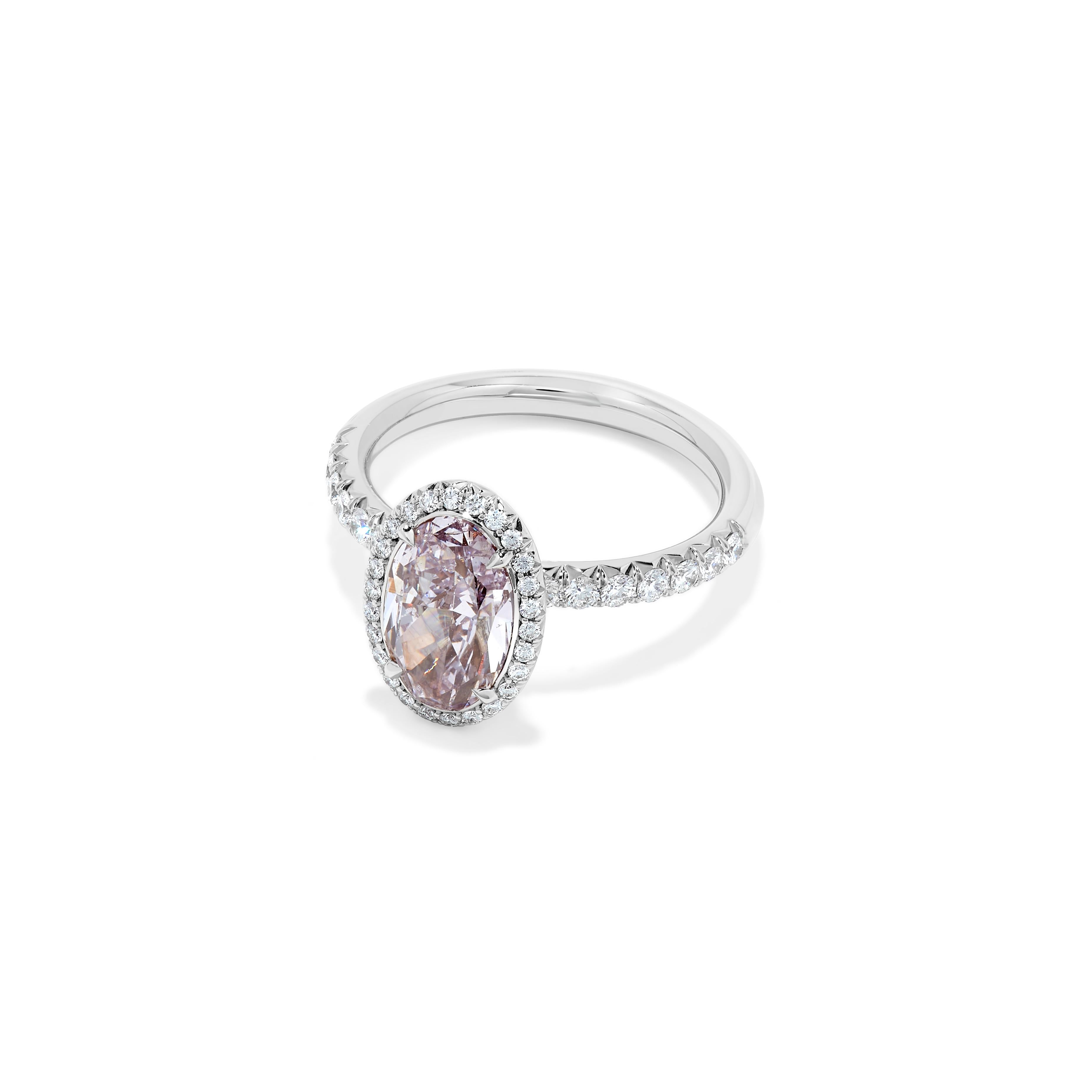 This ring features a 2 carat Fancy Purple-Pink SI2 Clarity diamond. The stone is completely clean to the eye. With a micro-pave platinum mounting featuring 40 stones for a total weight of 0.40 cts. Along with GIA Certificate. Size 6. 

Resizeable