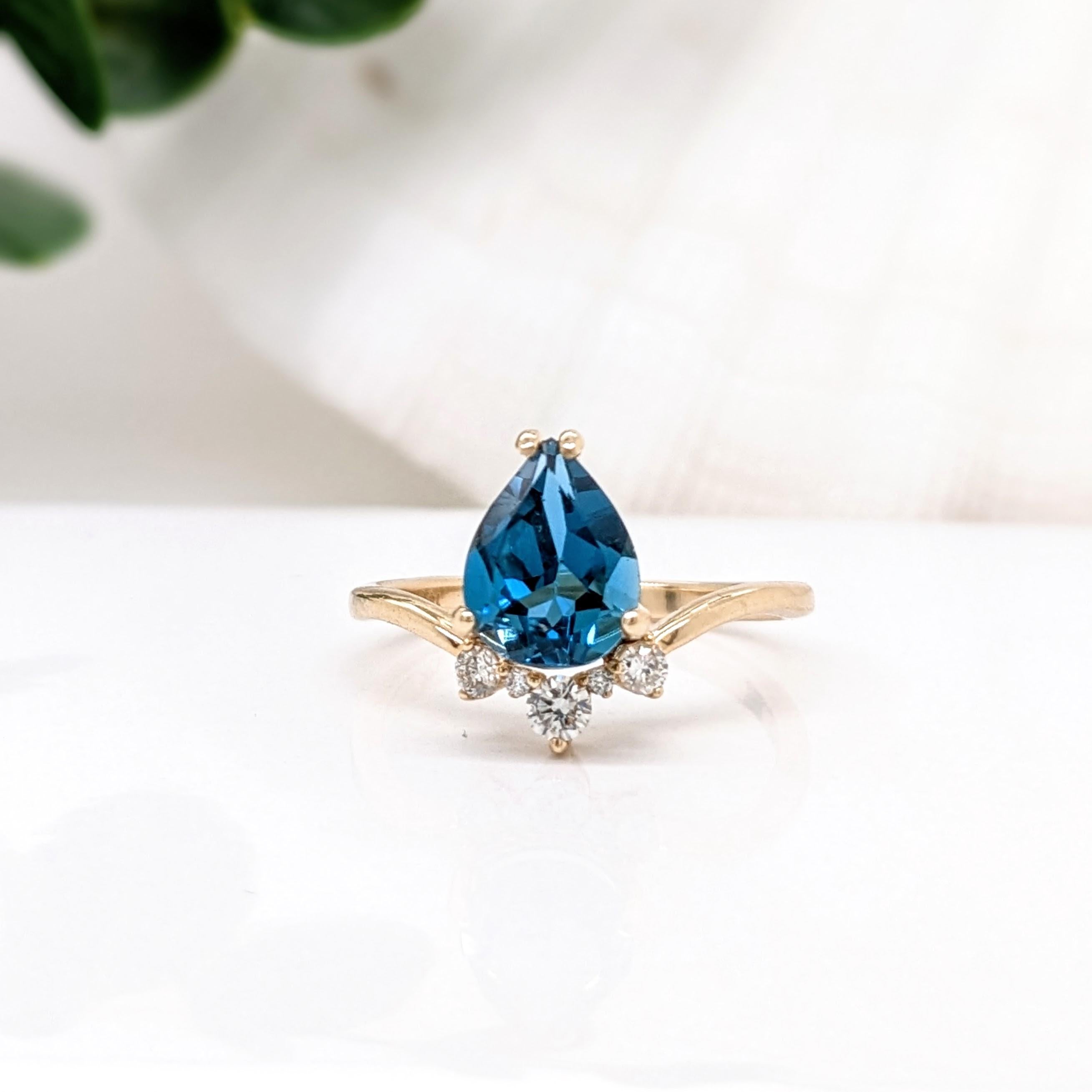 A gorgeous pear cut london blue topaz set in a 14k yellow gold ring with diamond accents in a shape reminiscent of a tiara. A beautiful and unique ring for any occasion!

Specifications:

Item Type: Ring
Center Stone: London Topaz
Treatment: