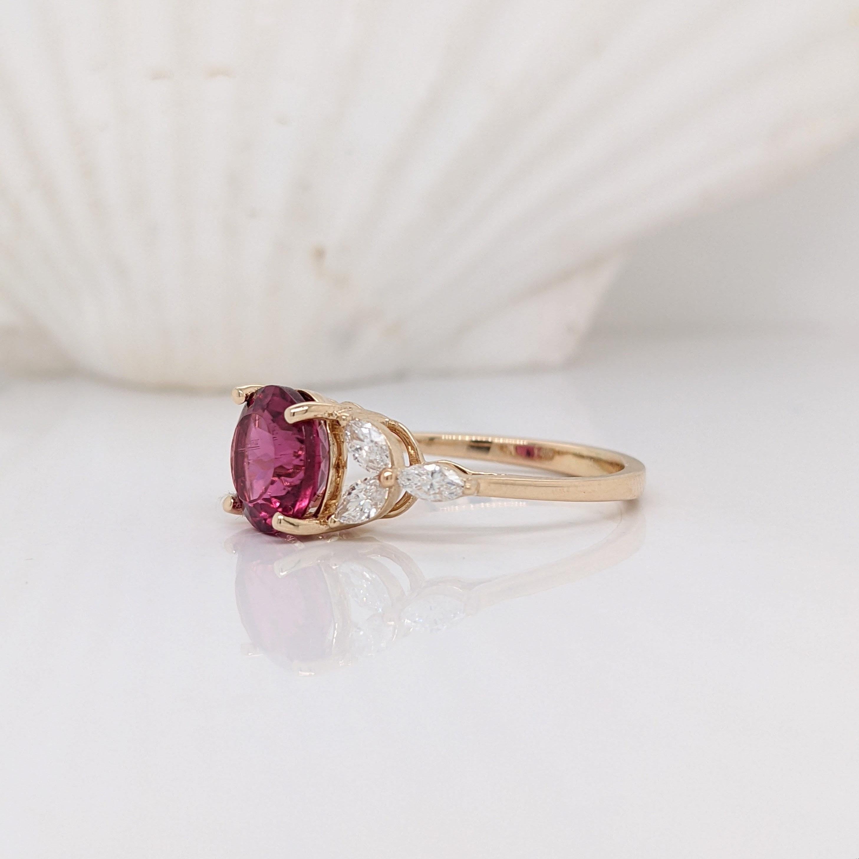 Bright and bold red-magenta Rubellite Tourmaline ring in 14k yellow gold. This stunning center stone is surrounded by marquis diamond accents giving it a floral look. A perfect ring for a unique bride. Perfect for special occasions such as