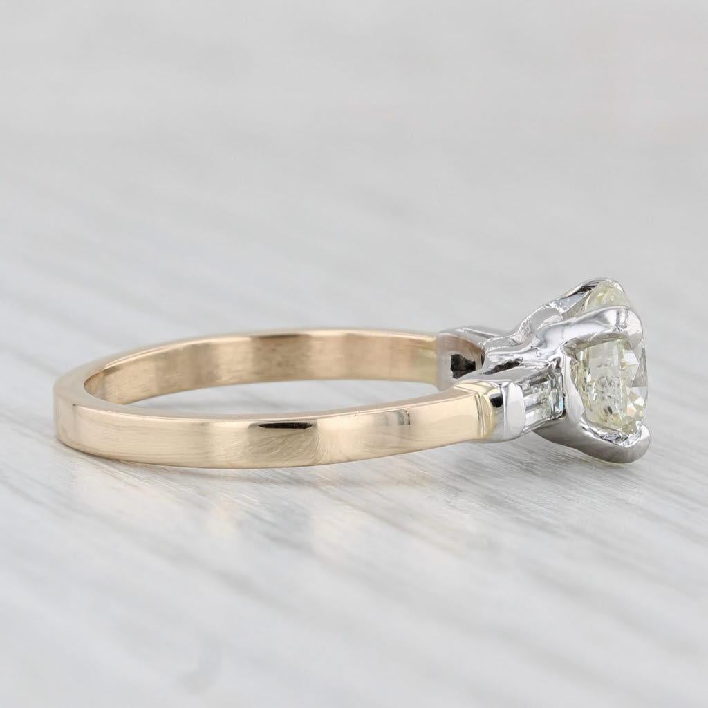 Gemstone Information:
- Natural Diamond -
Carats - 1.71ct 
Cut - Round Brilliant
Color - M
Clarity - I1
GIA - 2231248783 

- Natural Diamonds -
Total Carats - 0.29ctw
Cut - Baguette
Color - G - H
Clarity - VS1 - VS2

Metal: 14k Yellow Gold, Platinum