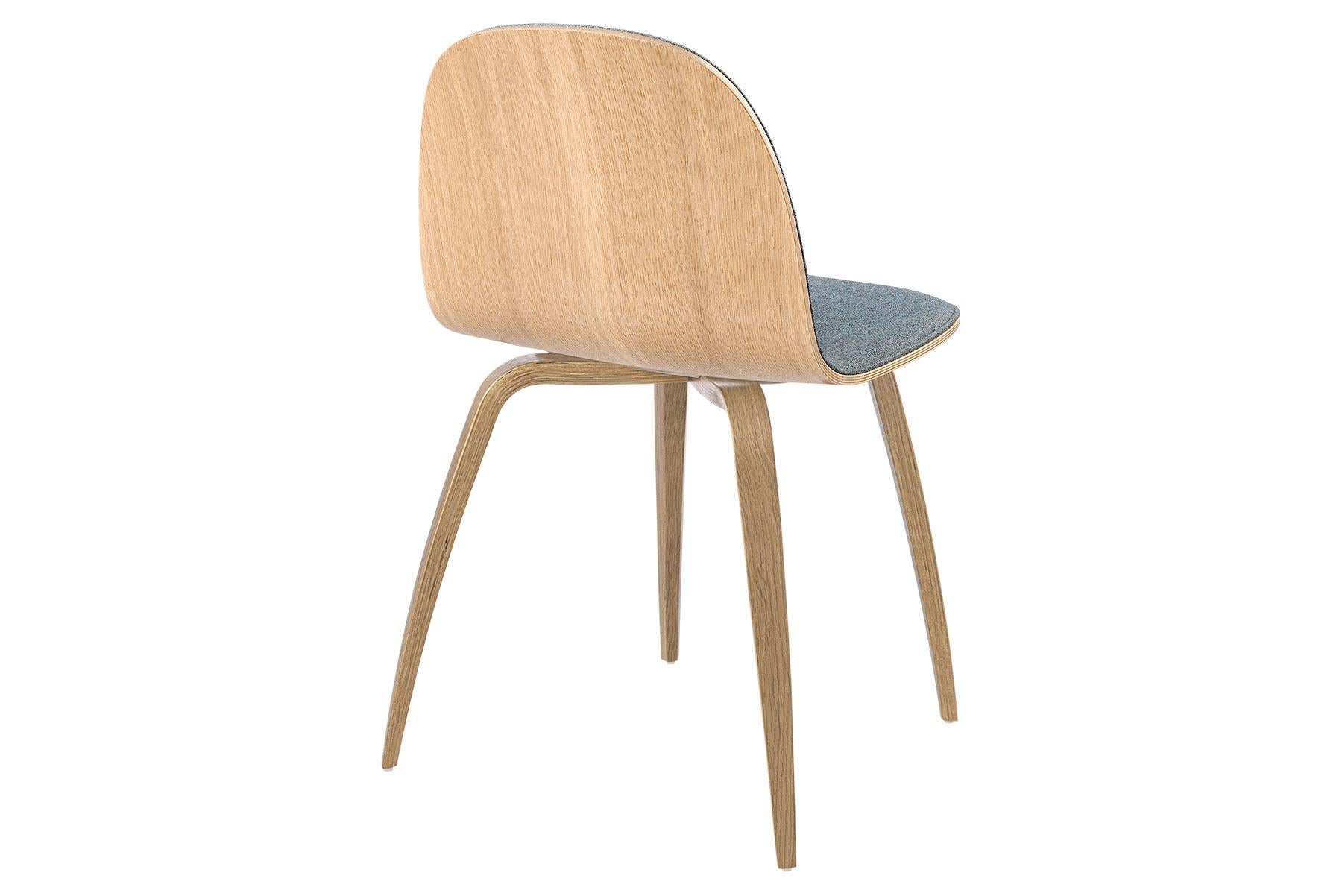 The Gubi 2D chair is a series of light dining chairs made from laminated veneer with options for front upholstery in a wide range of fabrics and leathers, suitable for both private and public spaces. Being an extension to the Classic Gubi 3D chair,